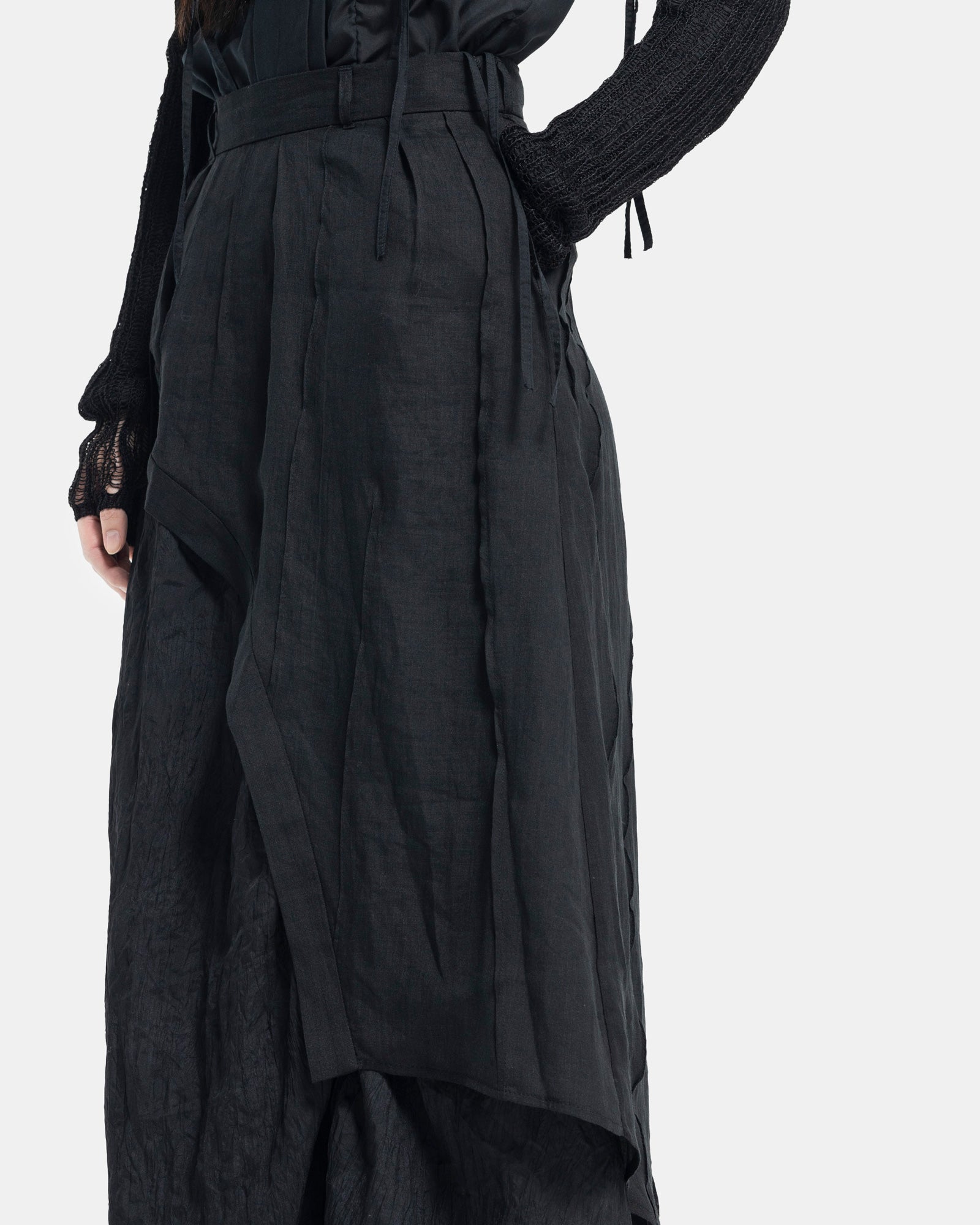 Female model wearing Professor.E black asymmetric skirt on white background