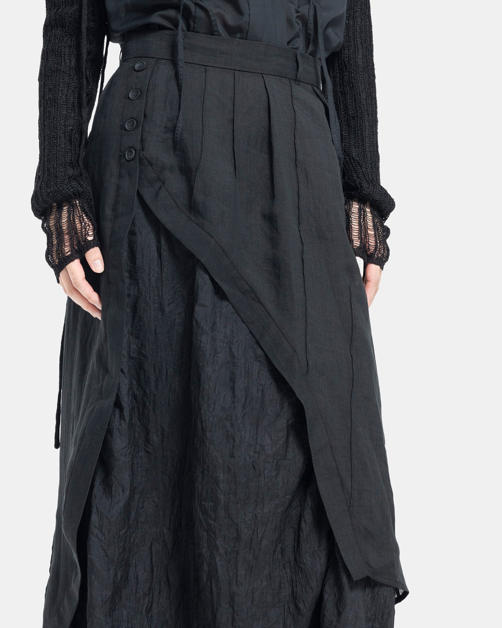 Female model wearing Professor.E black asymmetric skirt on white background
