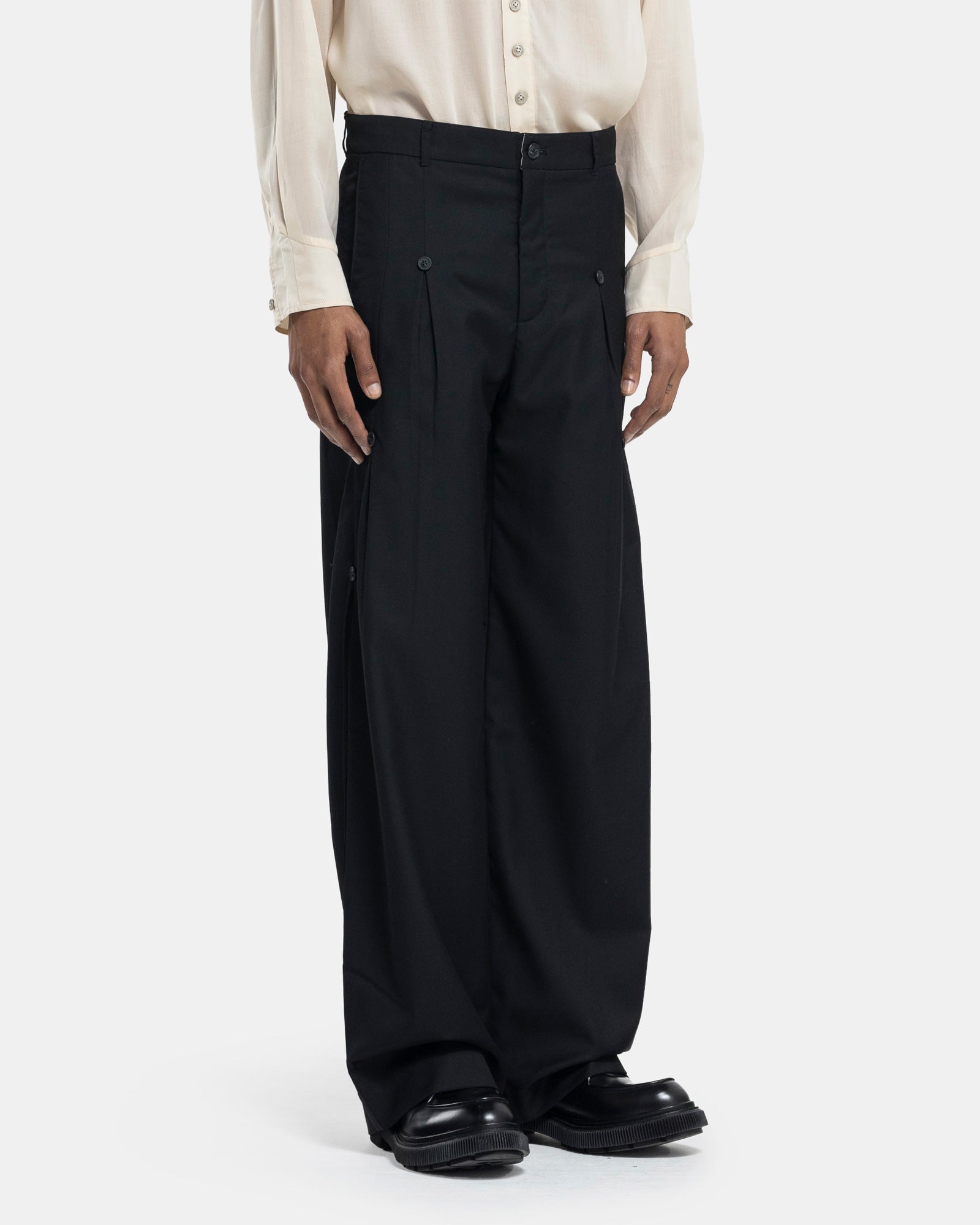 Male model wearing Professor.E black trousers on white background