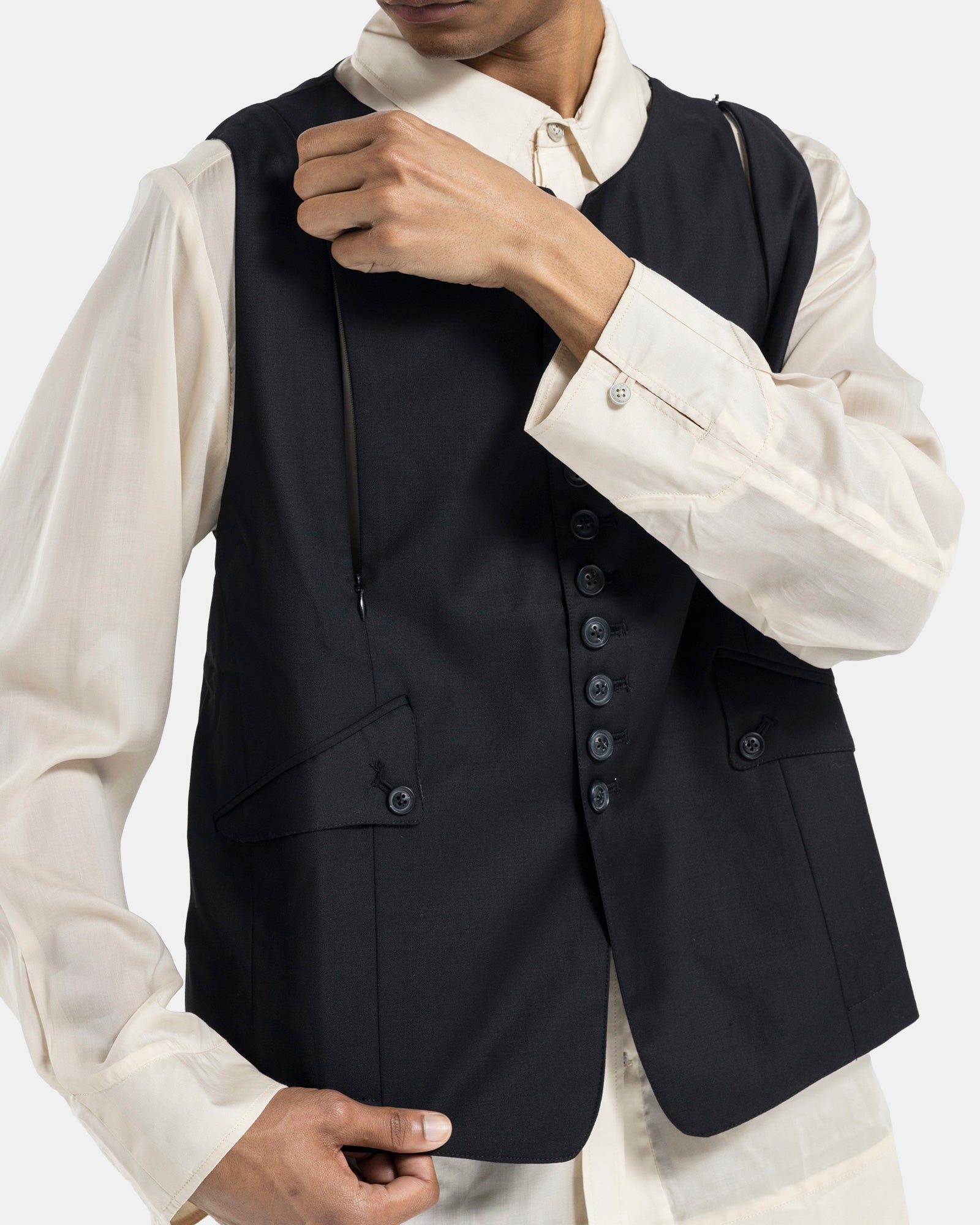 Male model wearing Professor.E black vest on white background