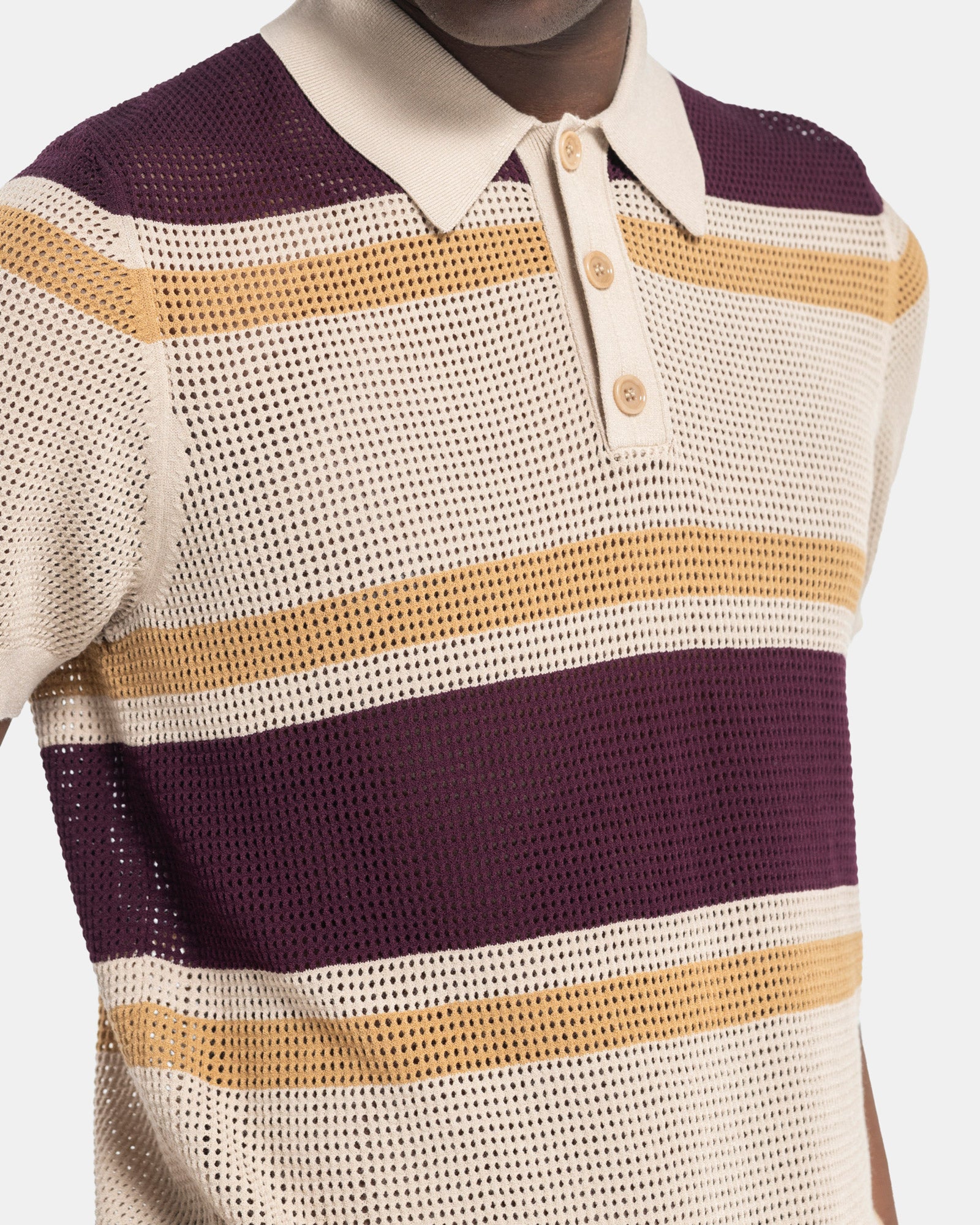 Close up Model wearing Dries Van Noten Mindo Stripe Polo in Beige on a white background