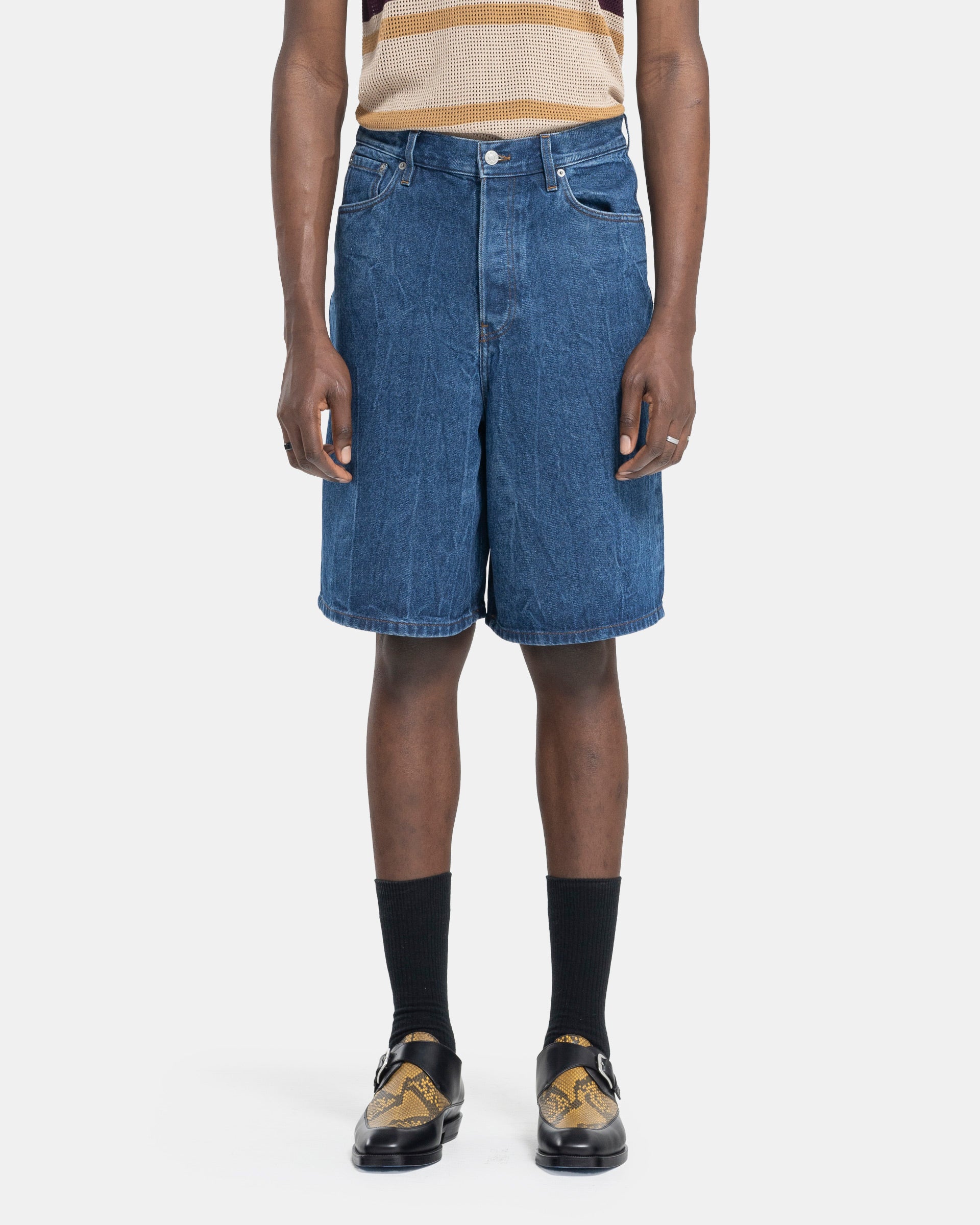 Model wearing Dries Van Noten Pinot Short Pants in Washed Blue on white background