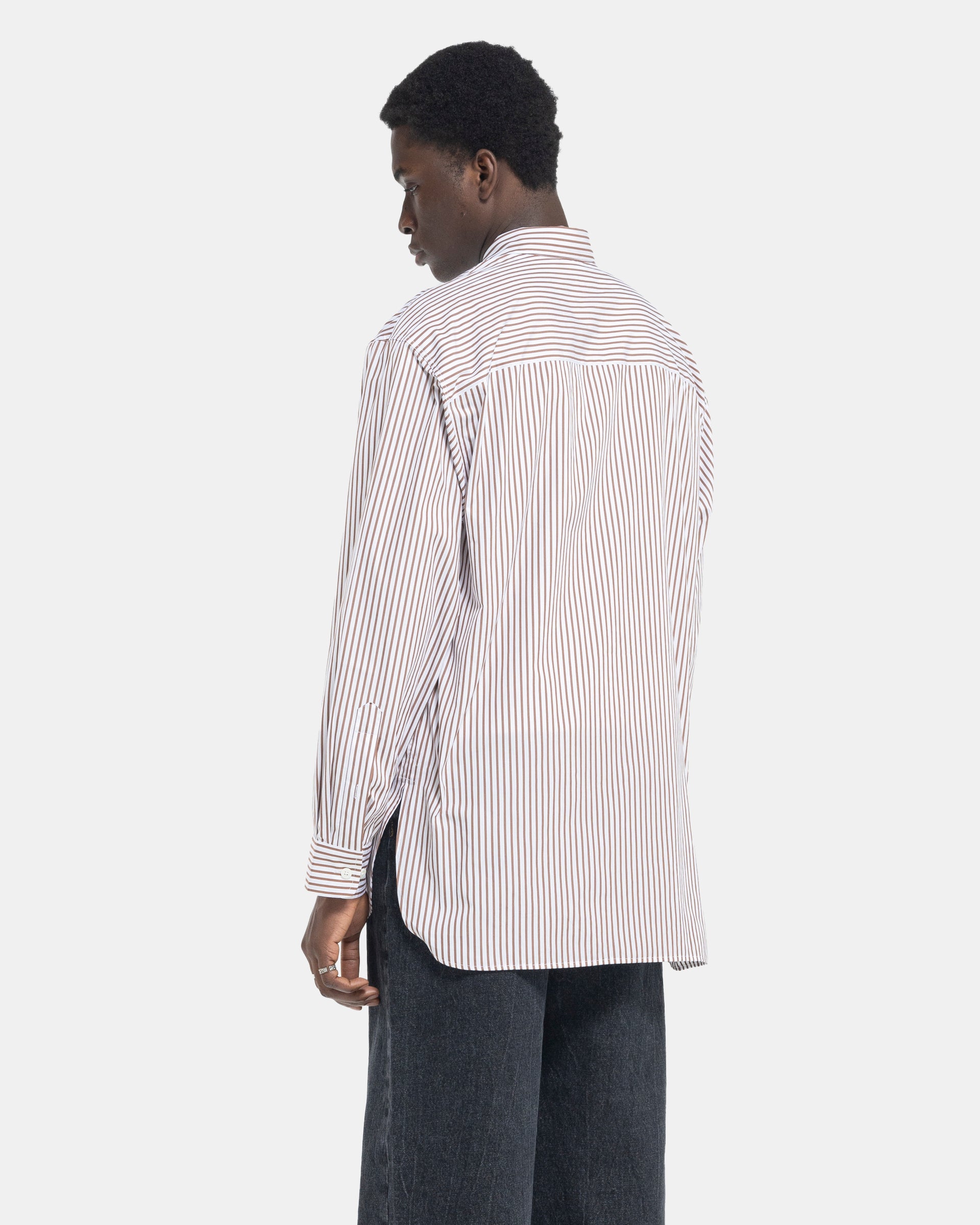 model wearing Dries Van Noten Calander Shirt in Brown stripe