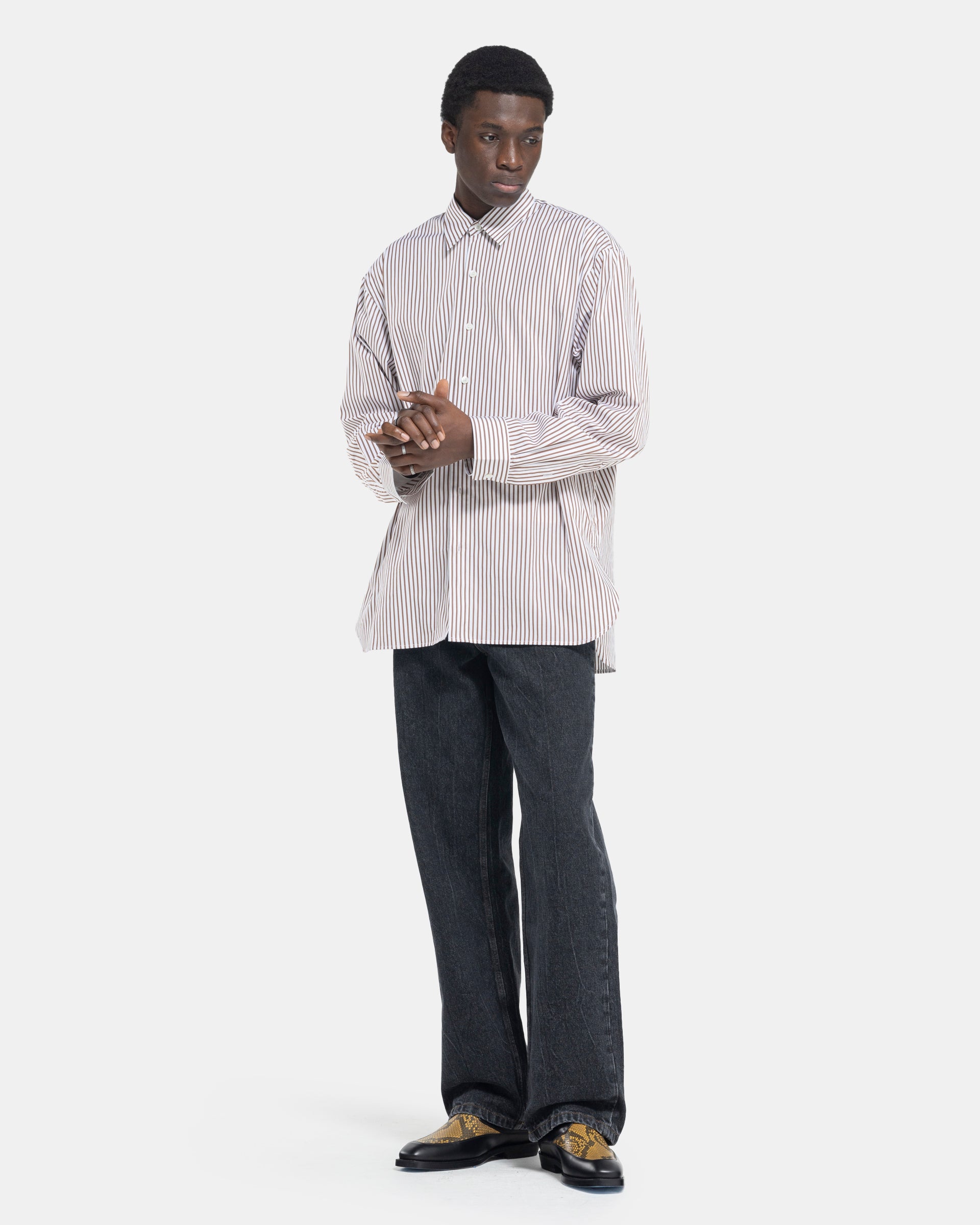 model wearing Dries Van Noten Calander Shirt in Brown stripe