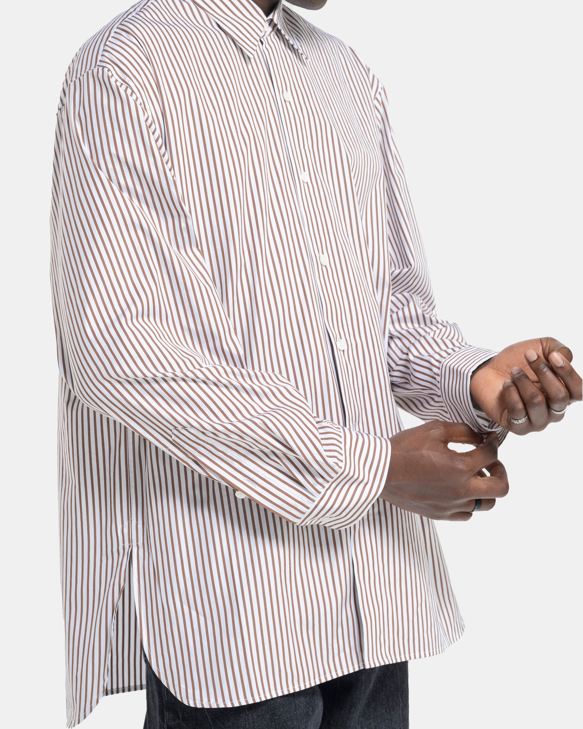 Close up of model wearing Dries Van Noten Calander Shirt in Brown stripe
