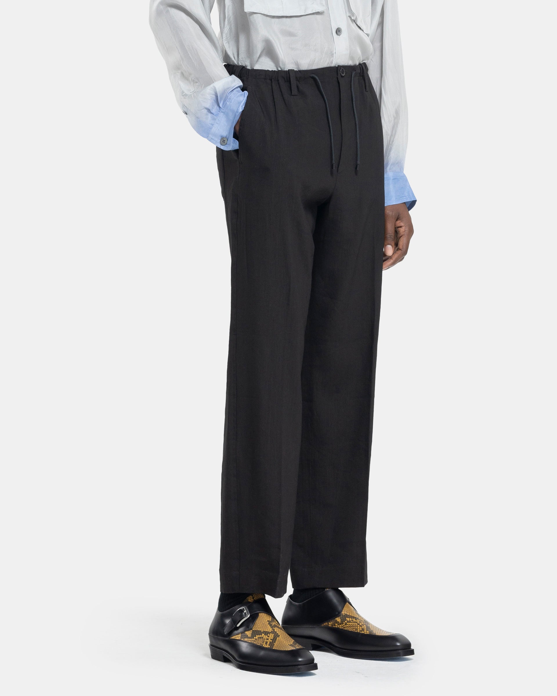Model wearing Dries Van Noten Penny Pants in Black on white background