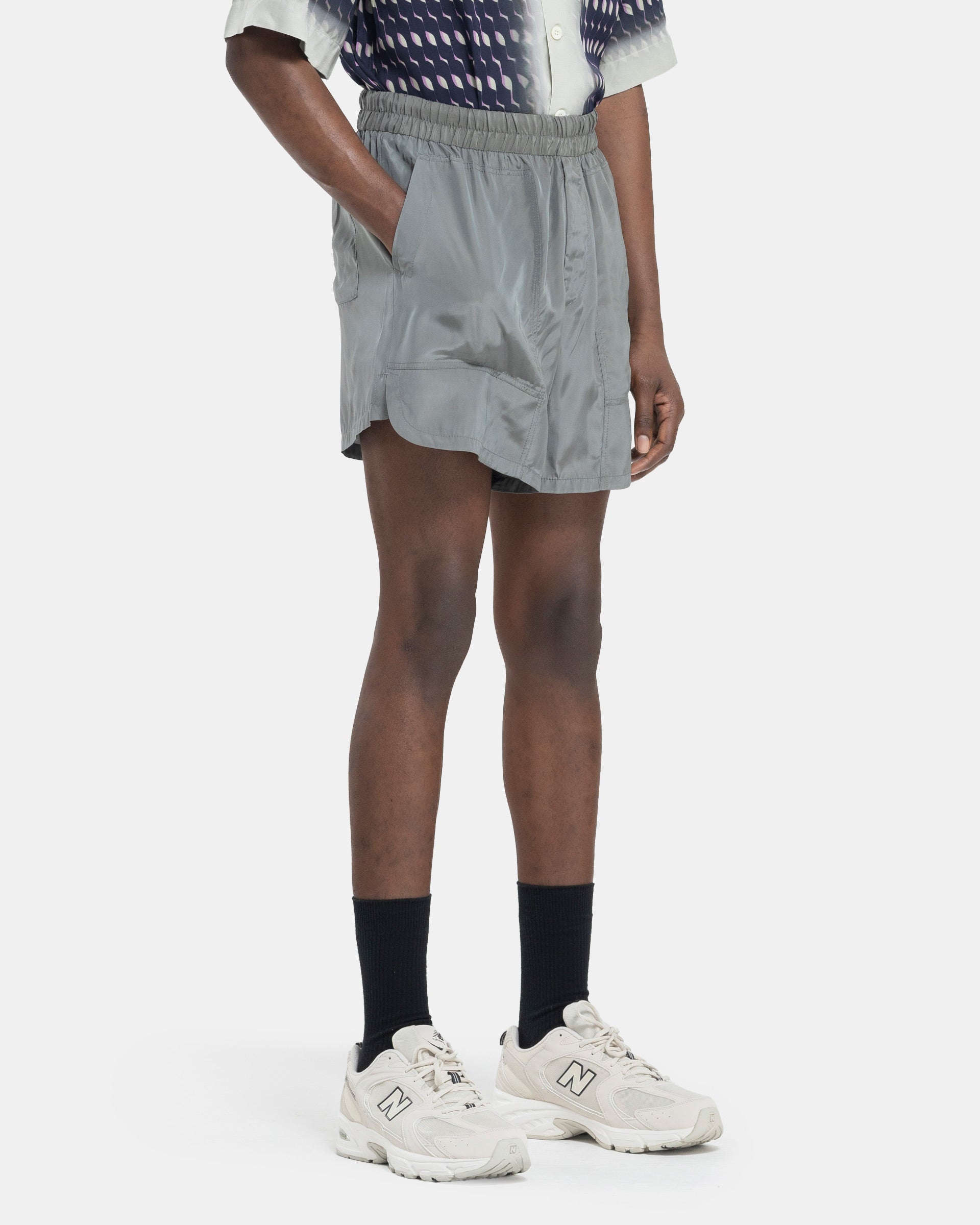 Model wearing Dries Van Noten Pooles Shorts in Grey on white background