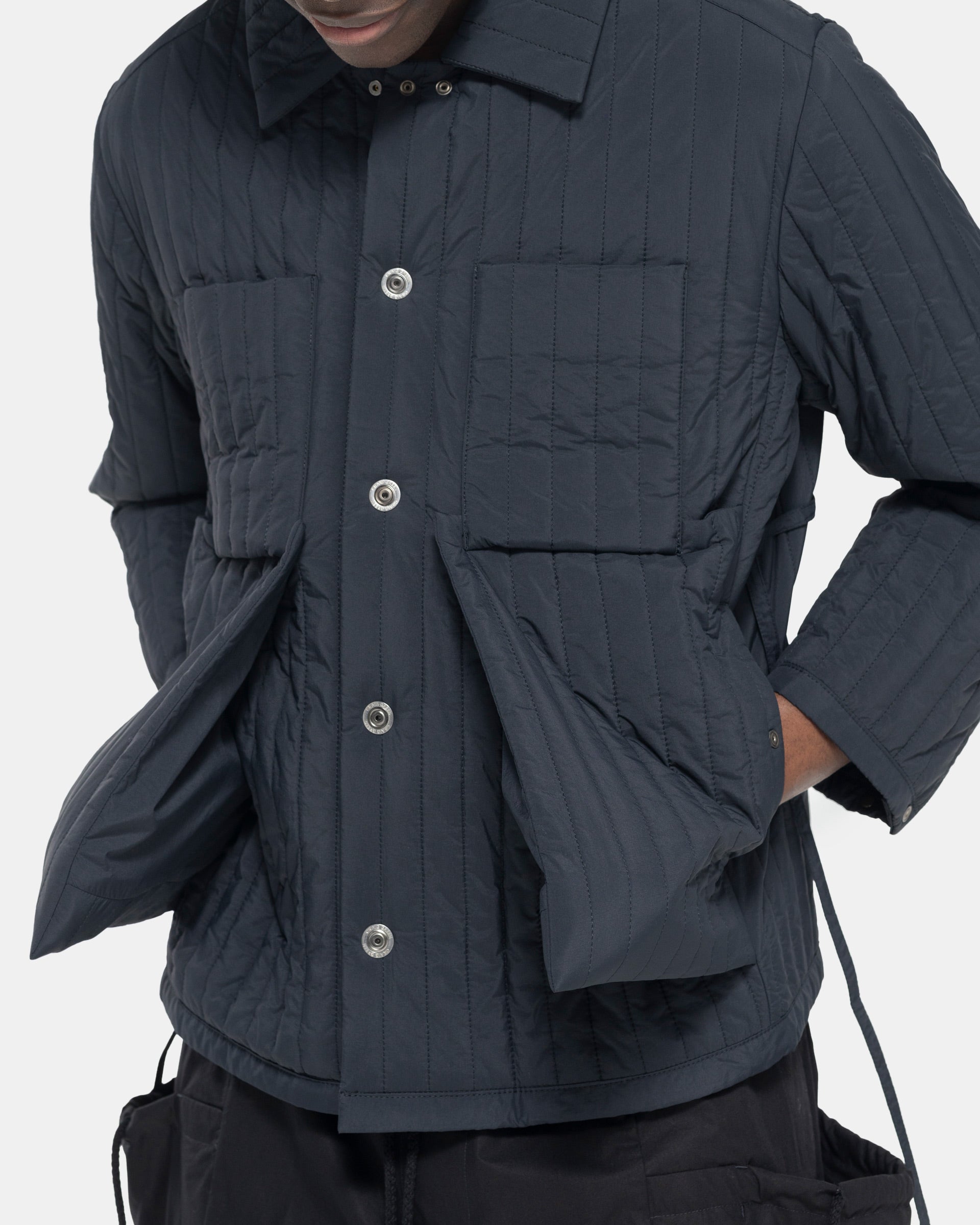 Model wearing Craig Green Quilted Worker Jacket in Black on white background