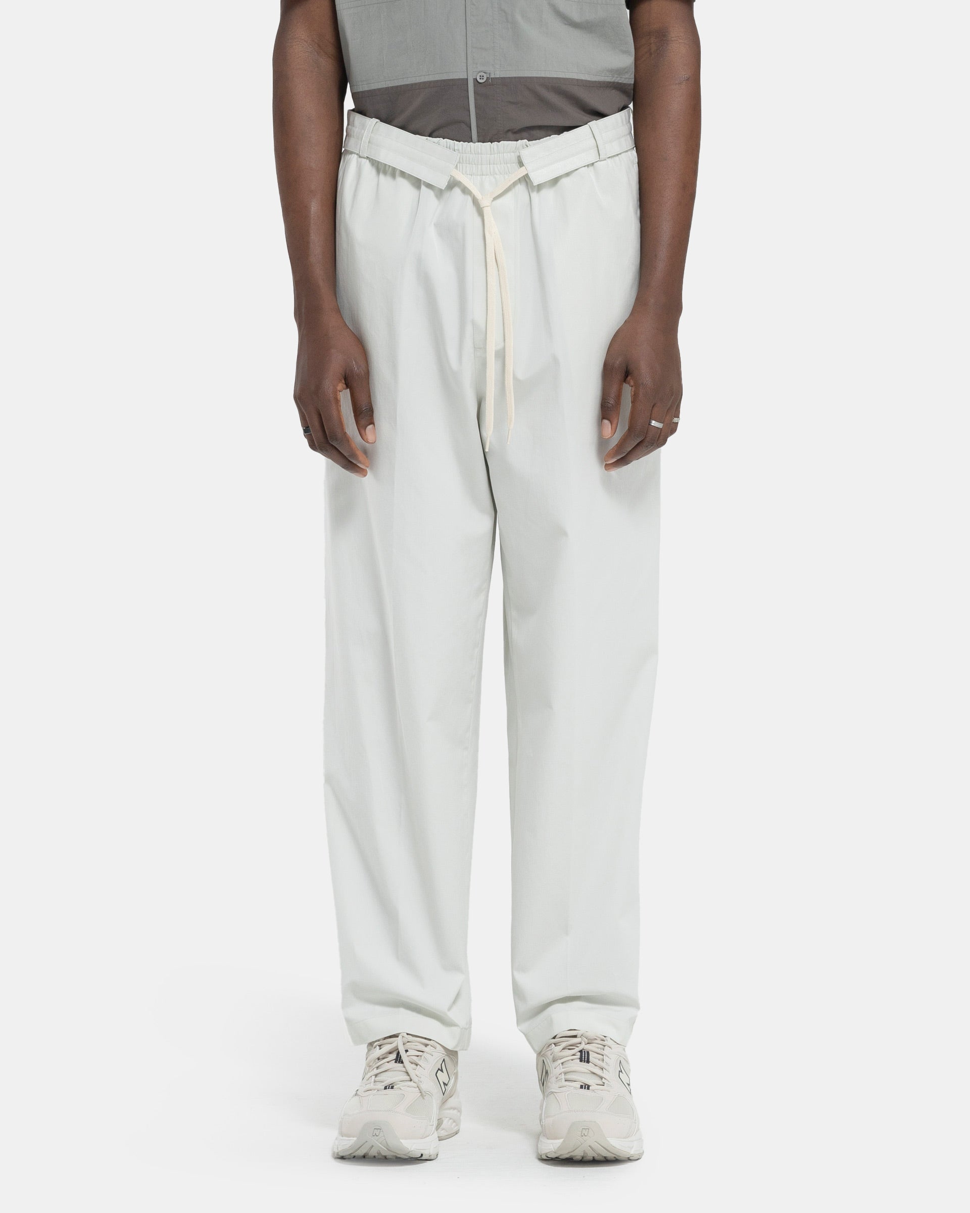 Model wearing Craig Green Circle Worker Trouser in Ecru on white background