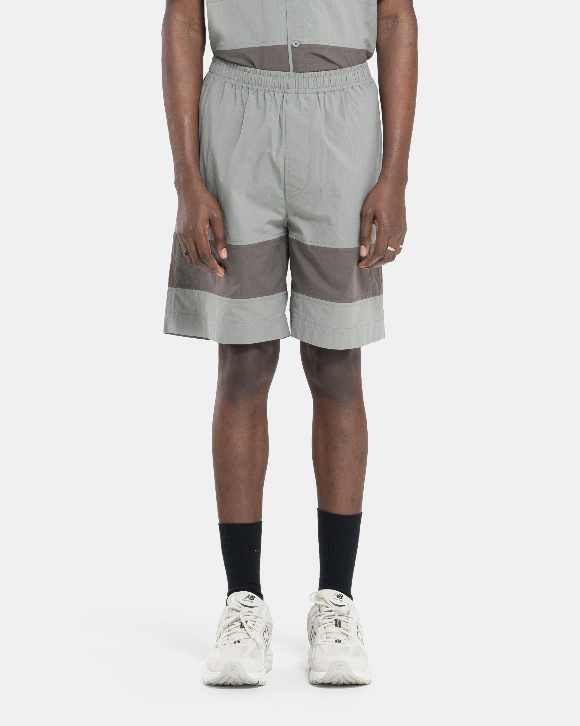 Model wearing Craig Green Barrel Shorts in Grey on white background