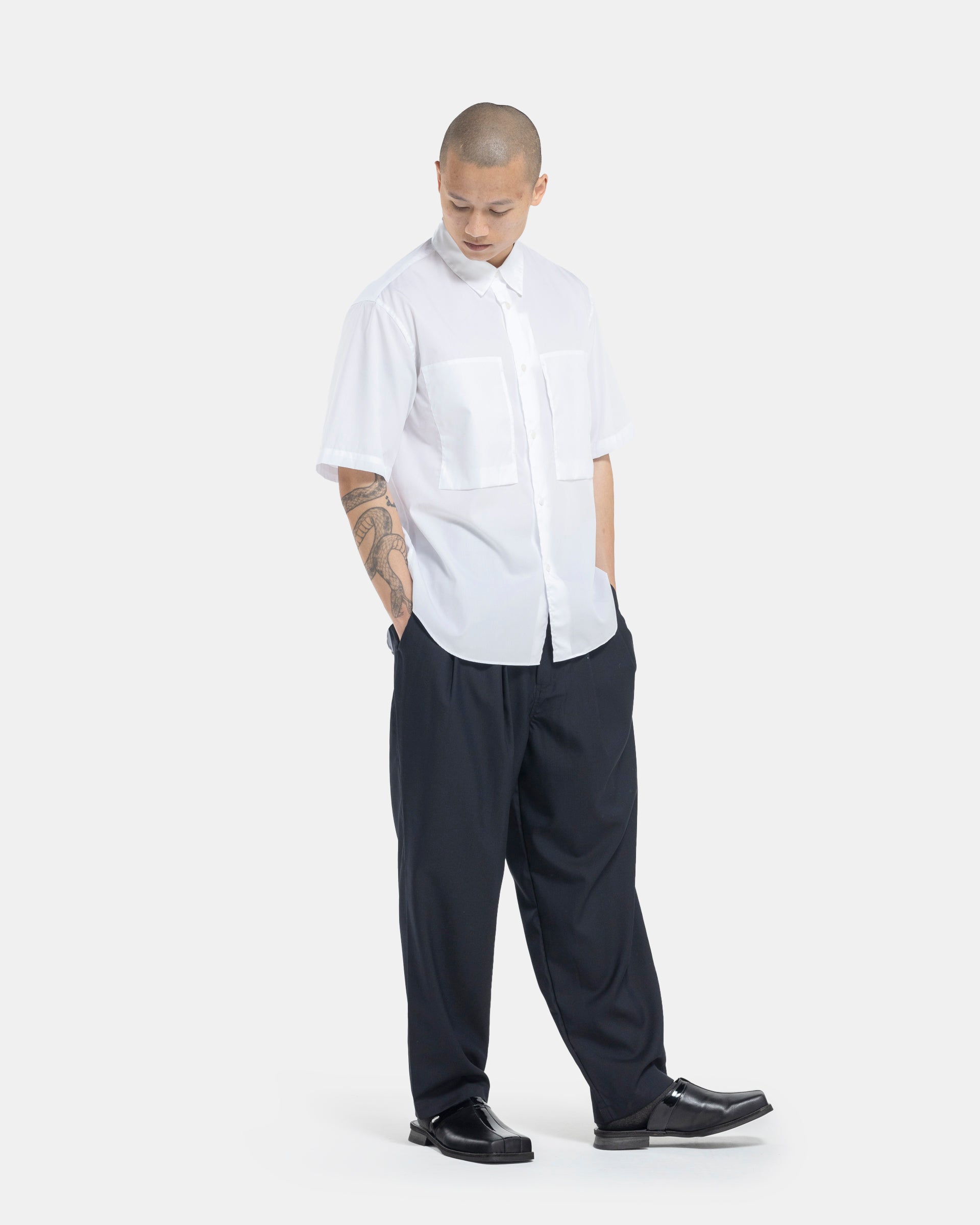 Male model wearing white Still By Hand shortsleeve shirt on white background