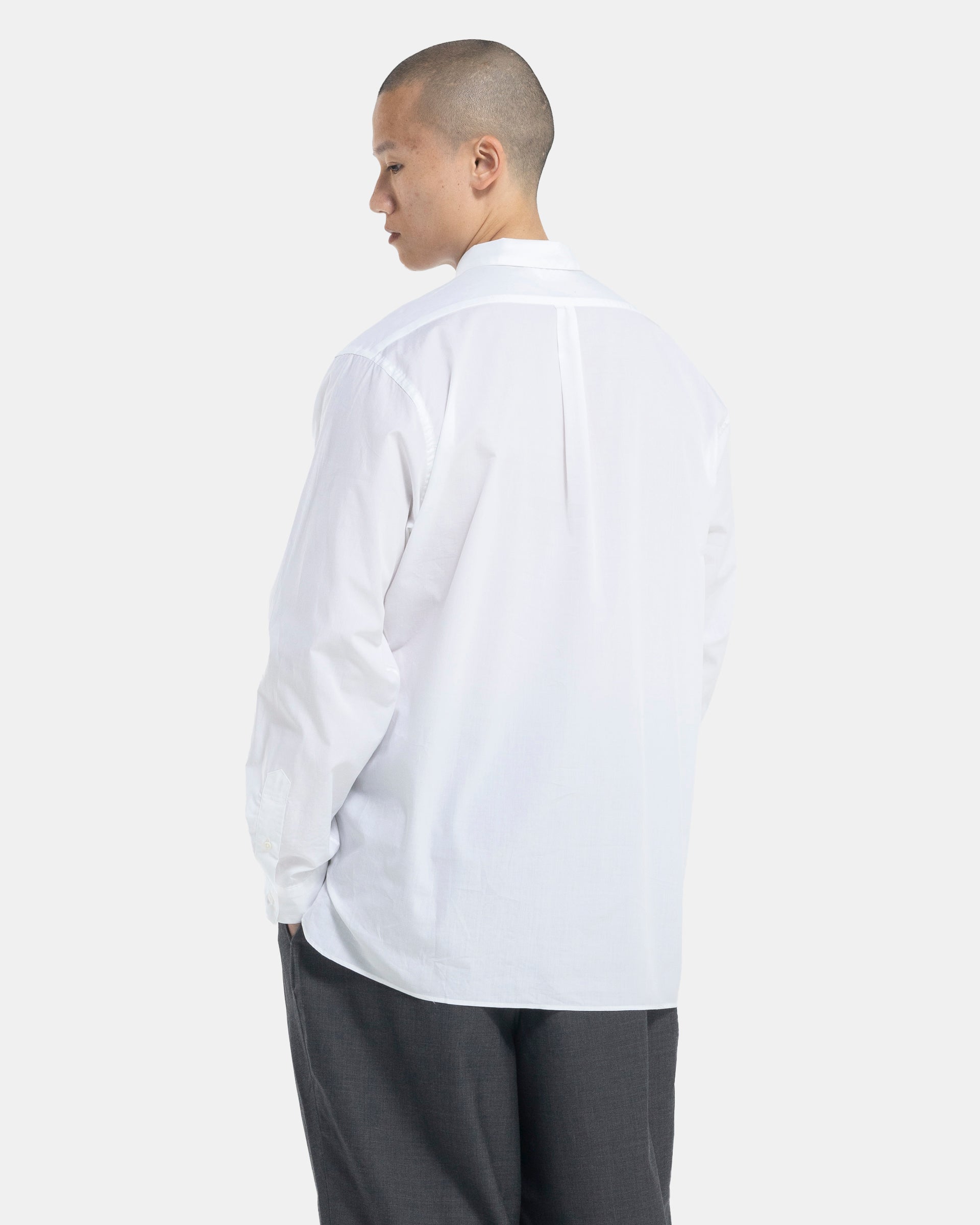 Male model wearing white Still By Hand shirt on white background
