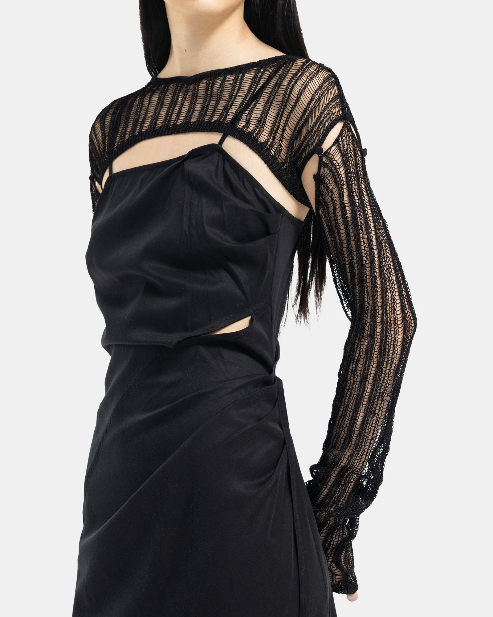 Female model wearing Professor.E black ruched slip dress on white background