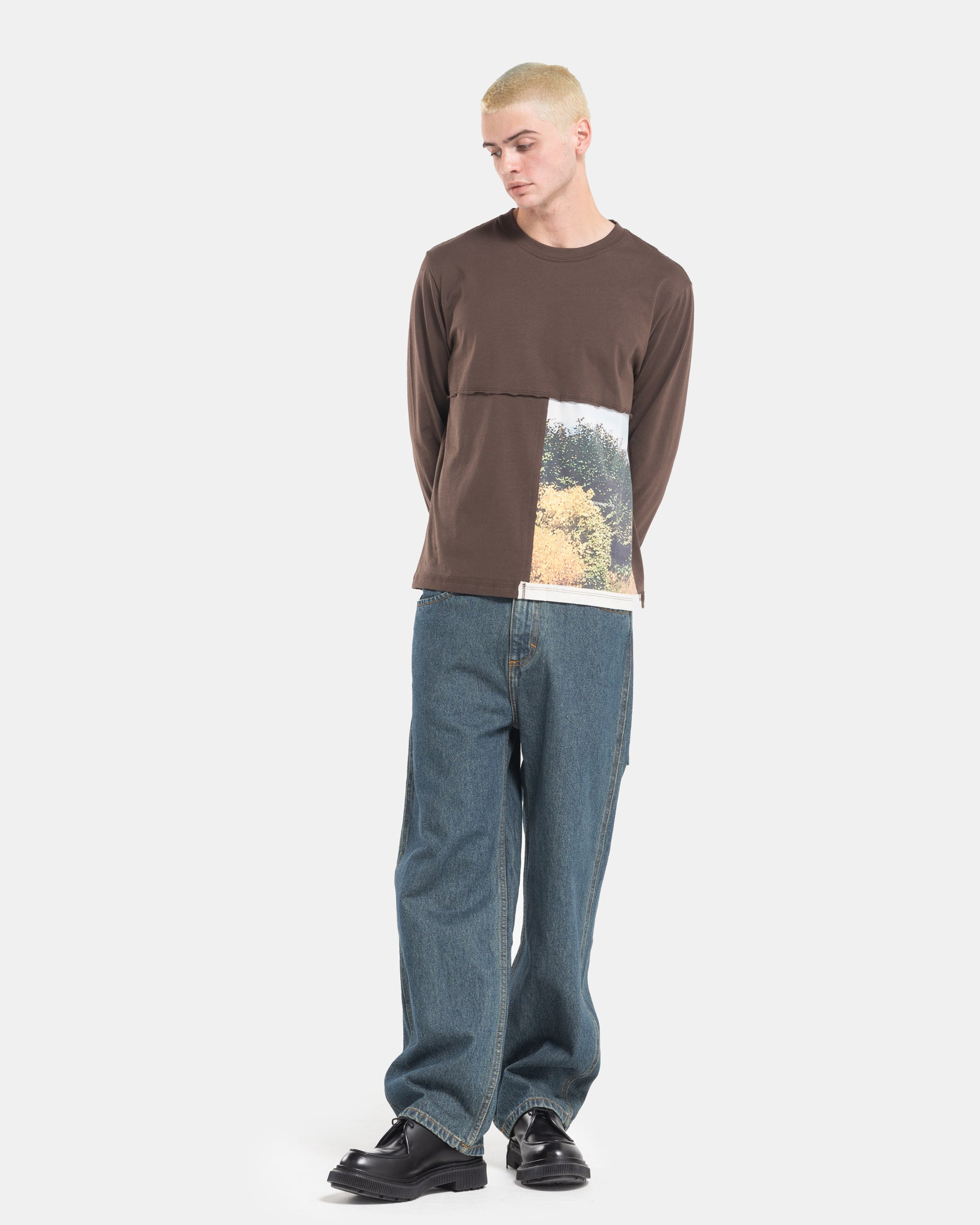 Male model wearing a brown Eckhaus Latta Lapped Longsleeve T-shirt with a printed design.