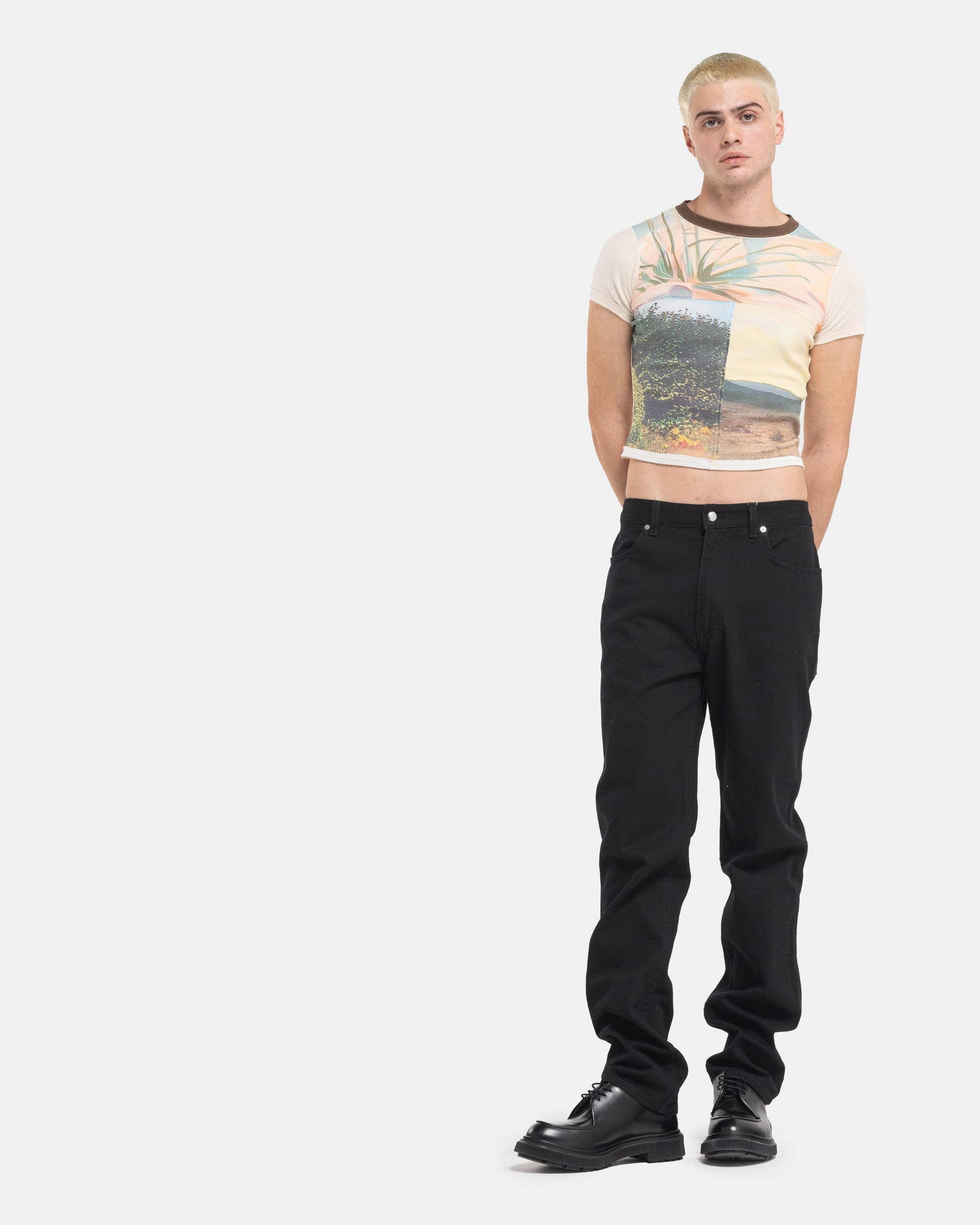 Male model wearing a Eckhaus Latta Lapped Baby Tee with a collage print design