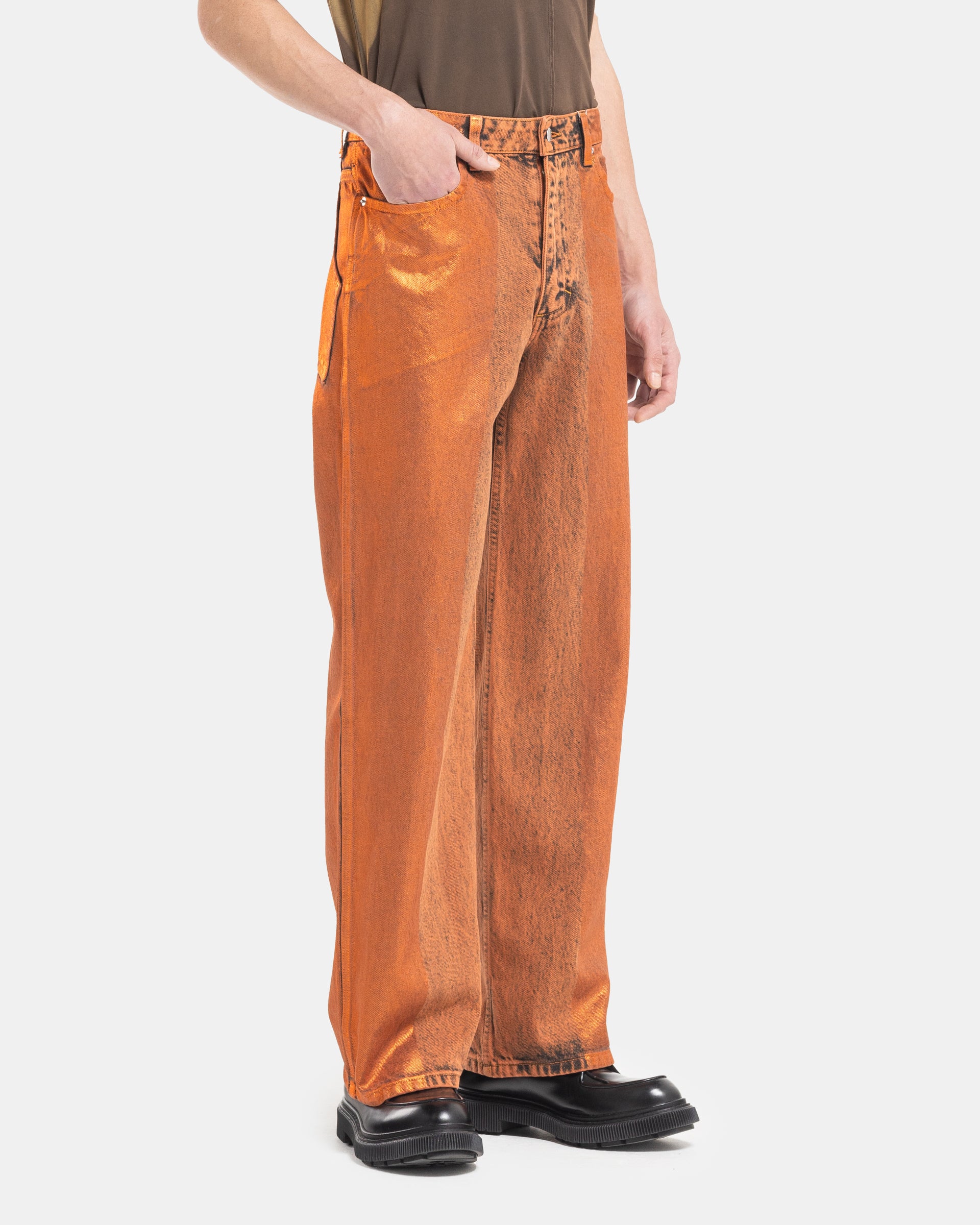Male model wearing Eckhaus Latta Wide Leg Jeans with a shiny coating