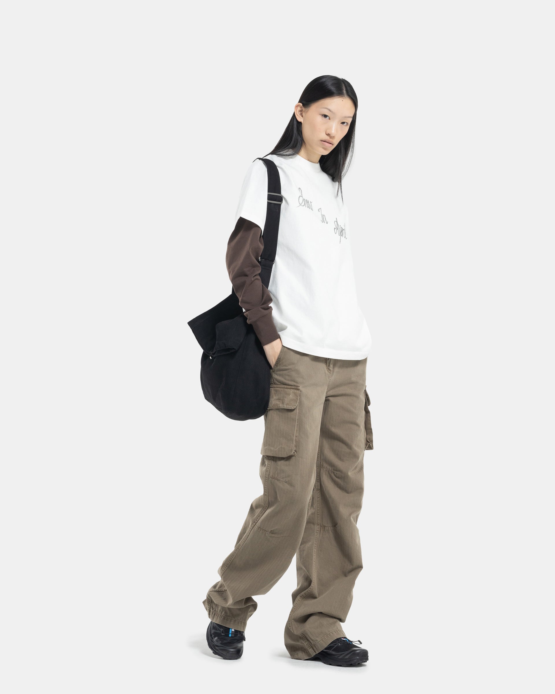 Female model wearing Khaki Cargo Pant from Our Legacy on white background