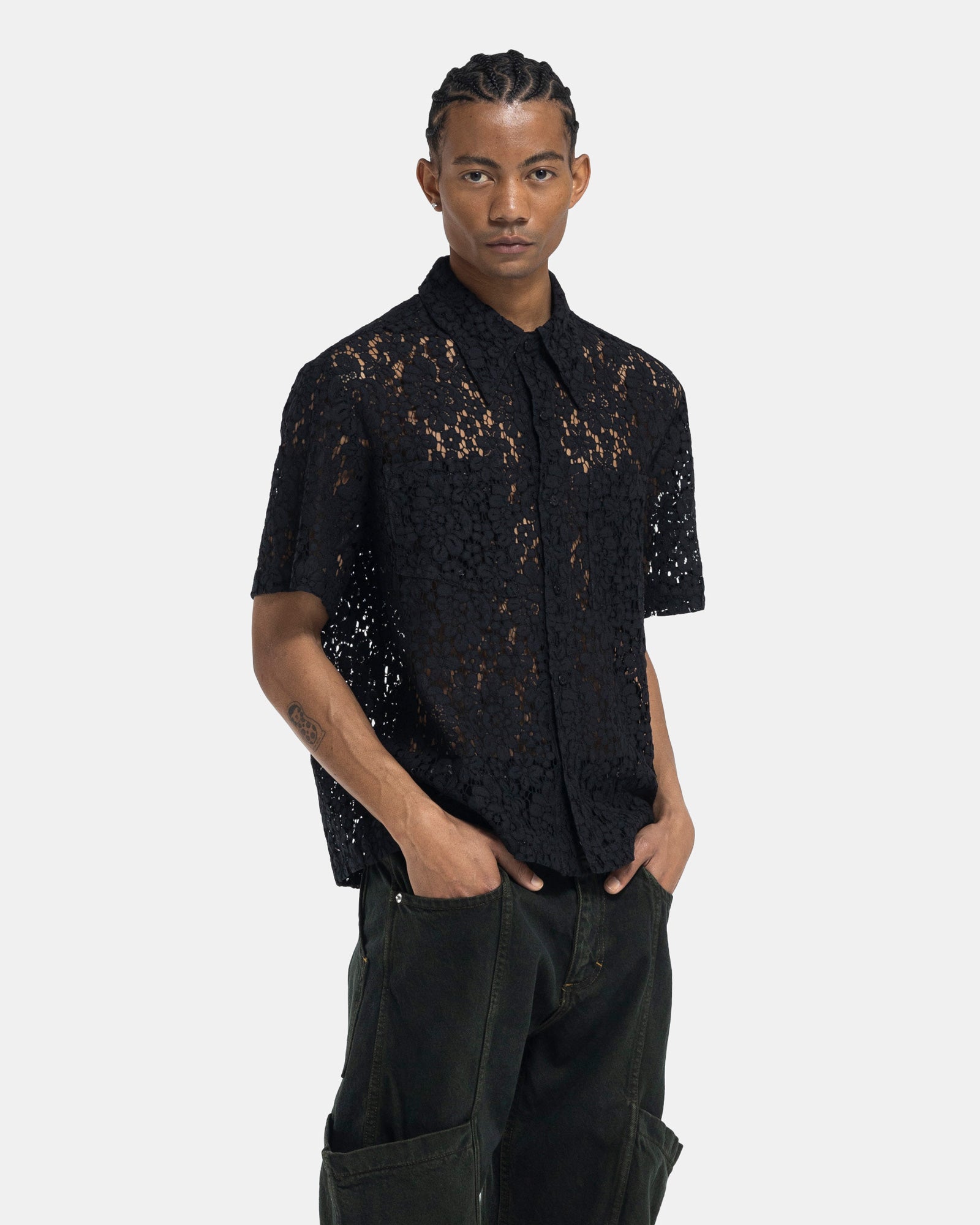 Male model wearing ECKHAUS LATTA black lace shirt on white background
