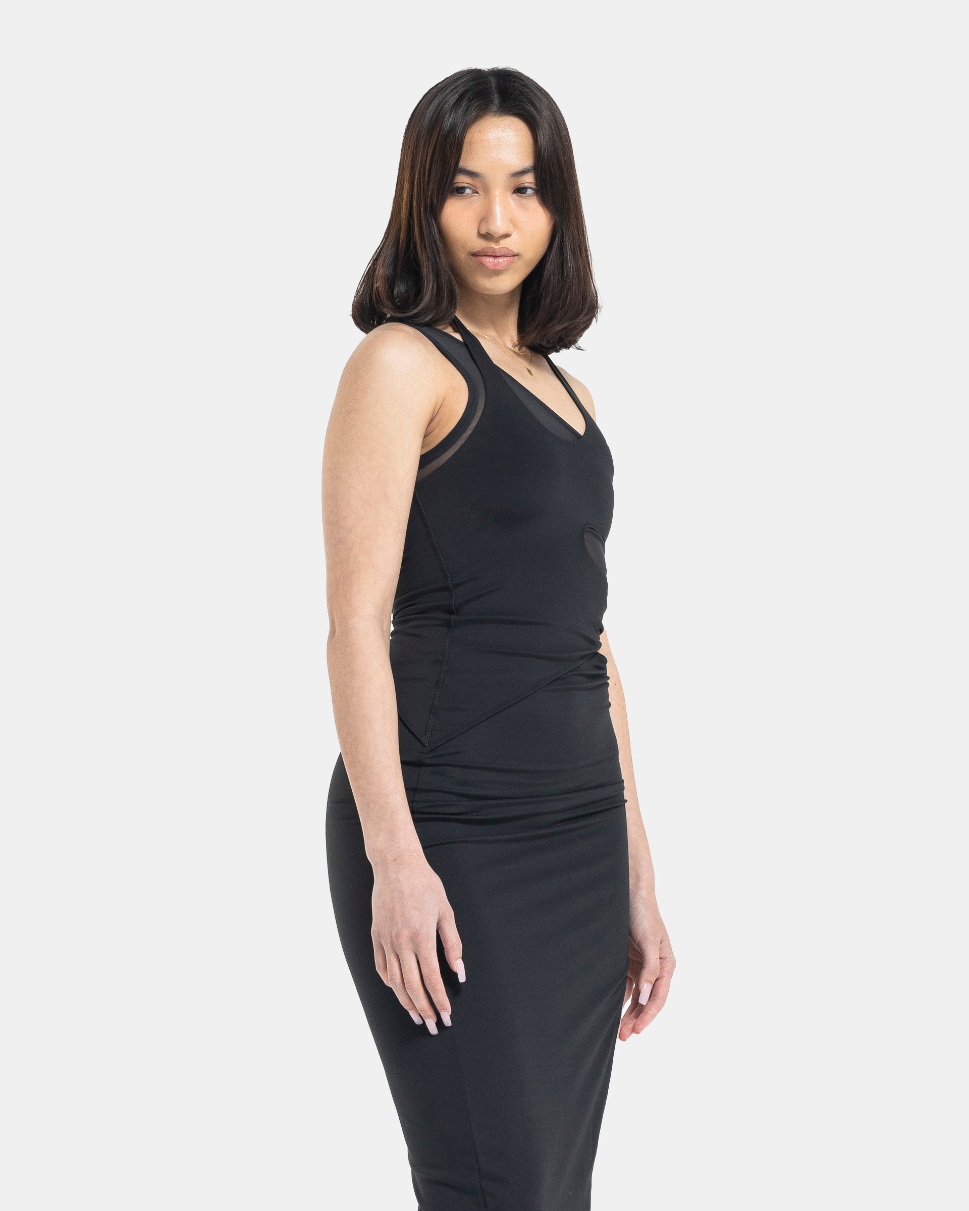 Female model wearing RUI x Adidas Black Dress on white background