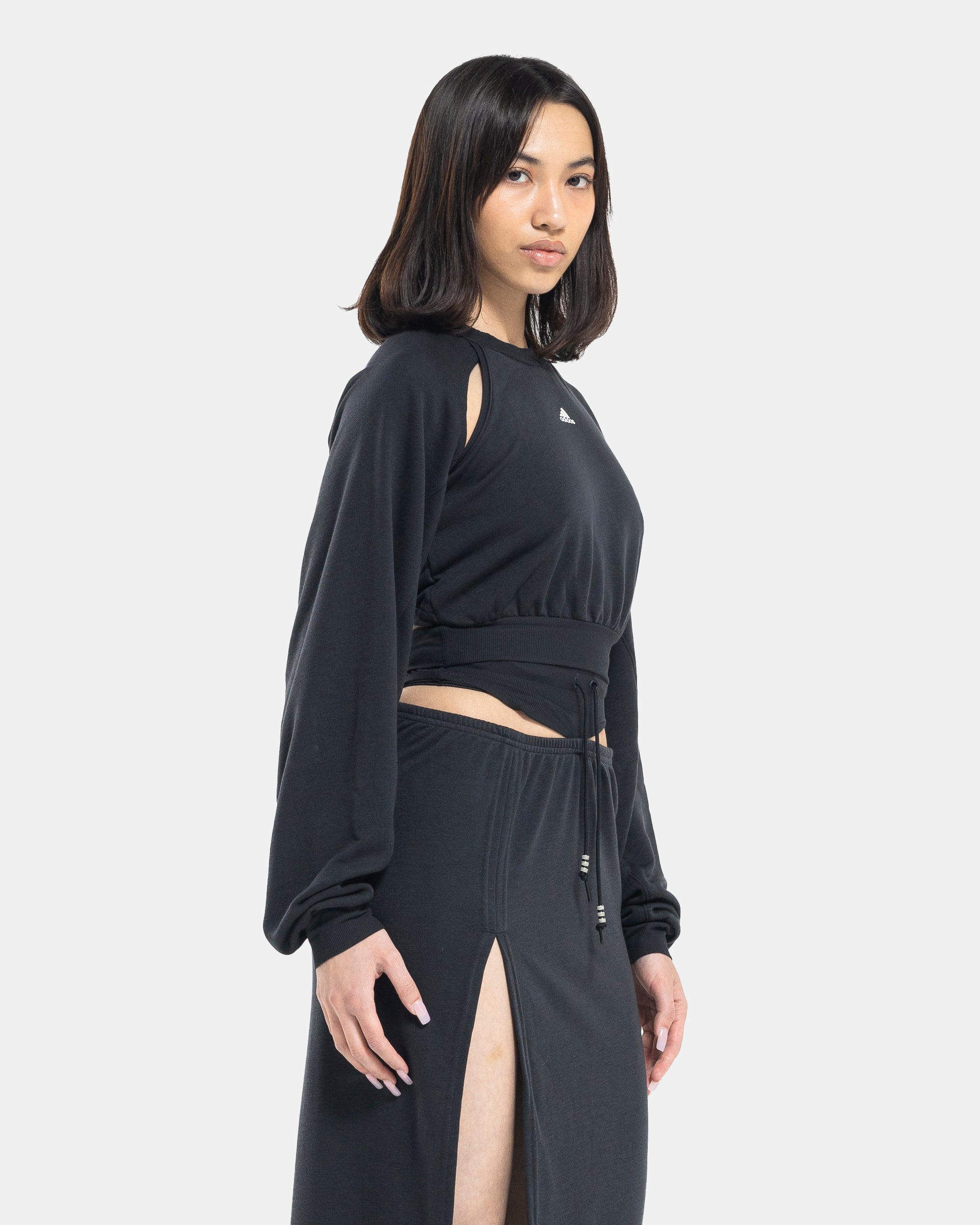 Female model wearing RUI x Adidas Black Sweatshirt on white background