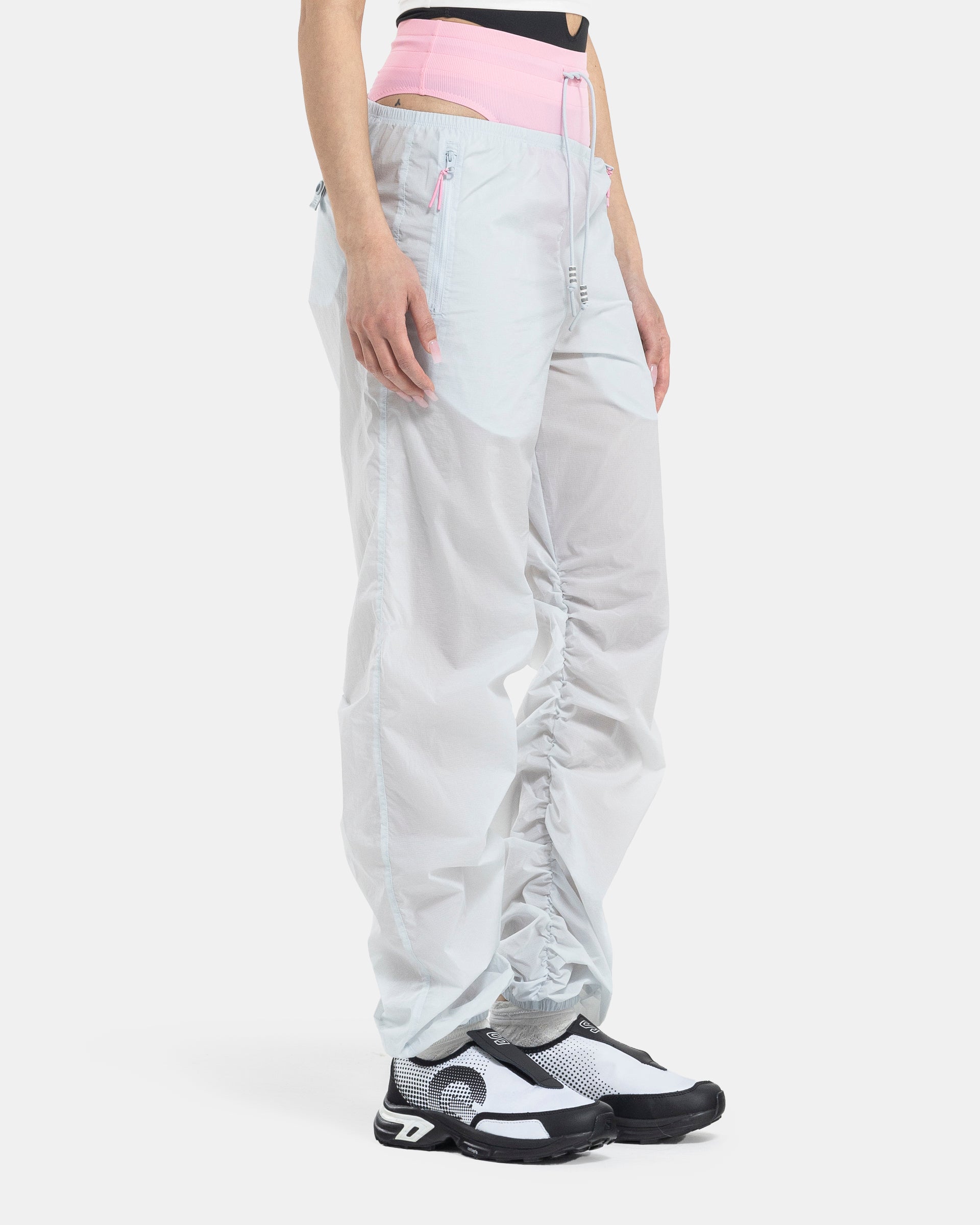Female model wearing RUI x Adidas Pink Track Pants on white background