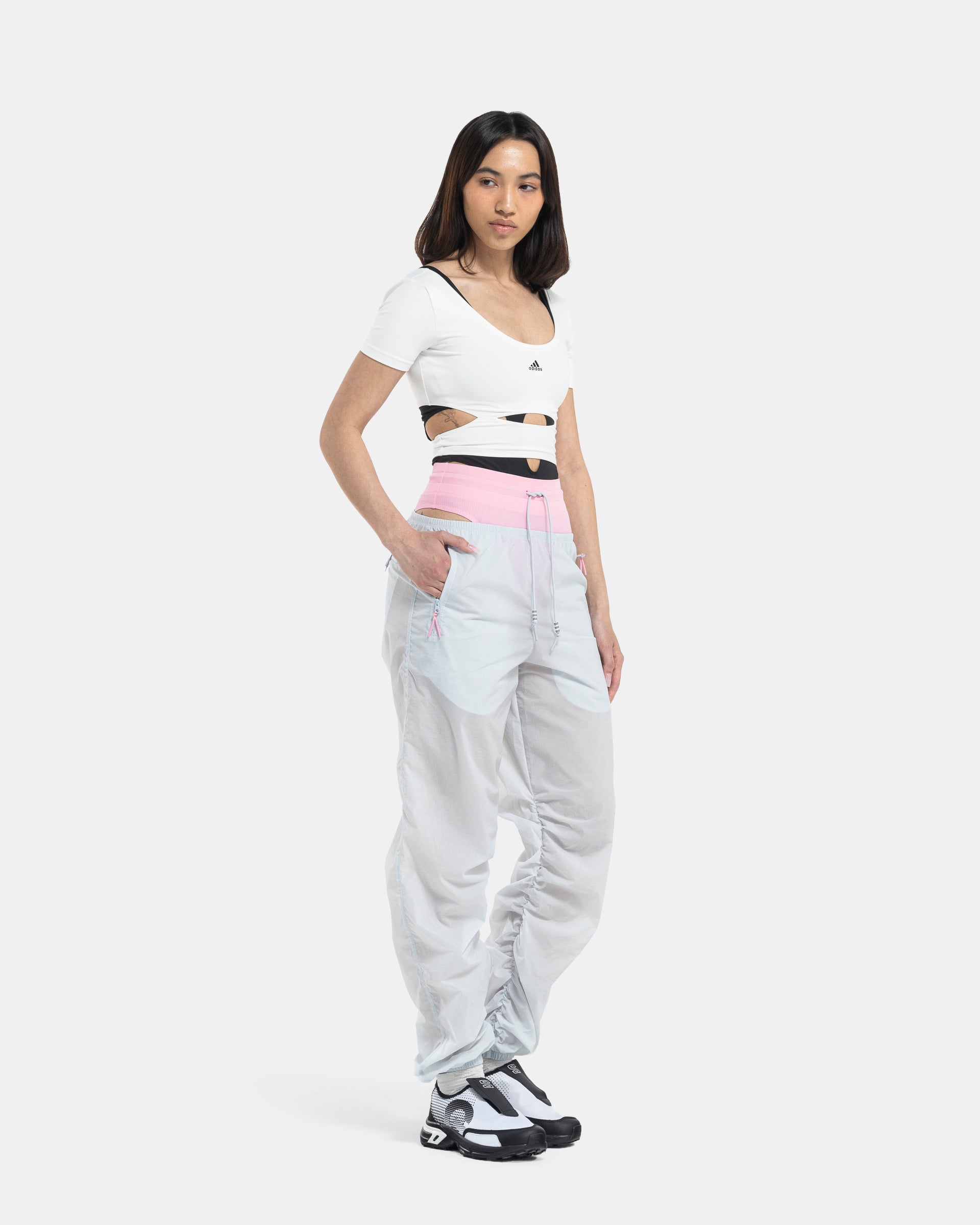 Female model wearing RUI x Adidas Pink Track Pants on white background