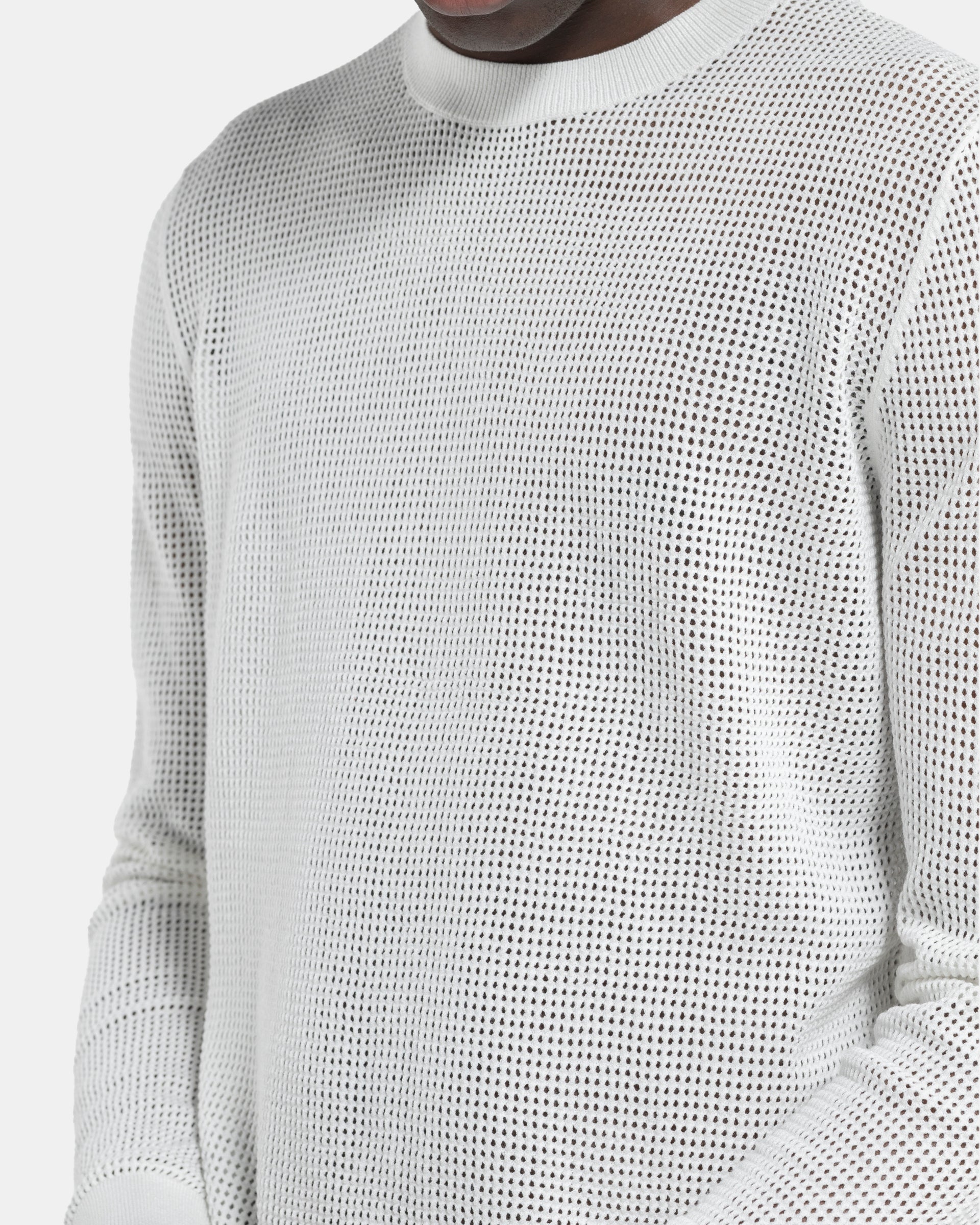 Close up Model wearing Dries Van Noten Mixed Sweater in White on a white background