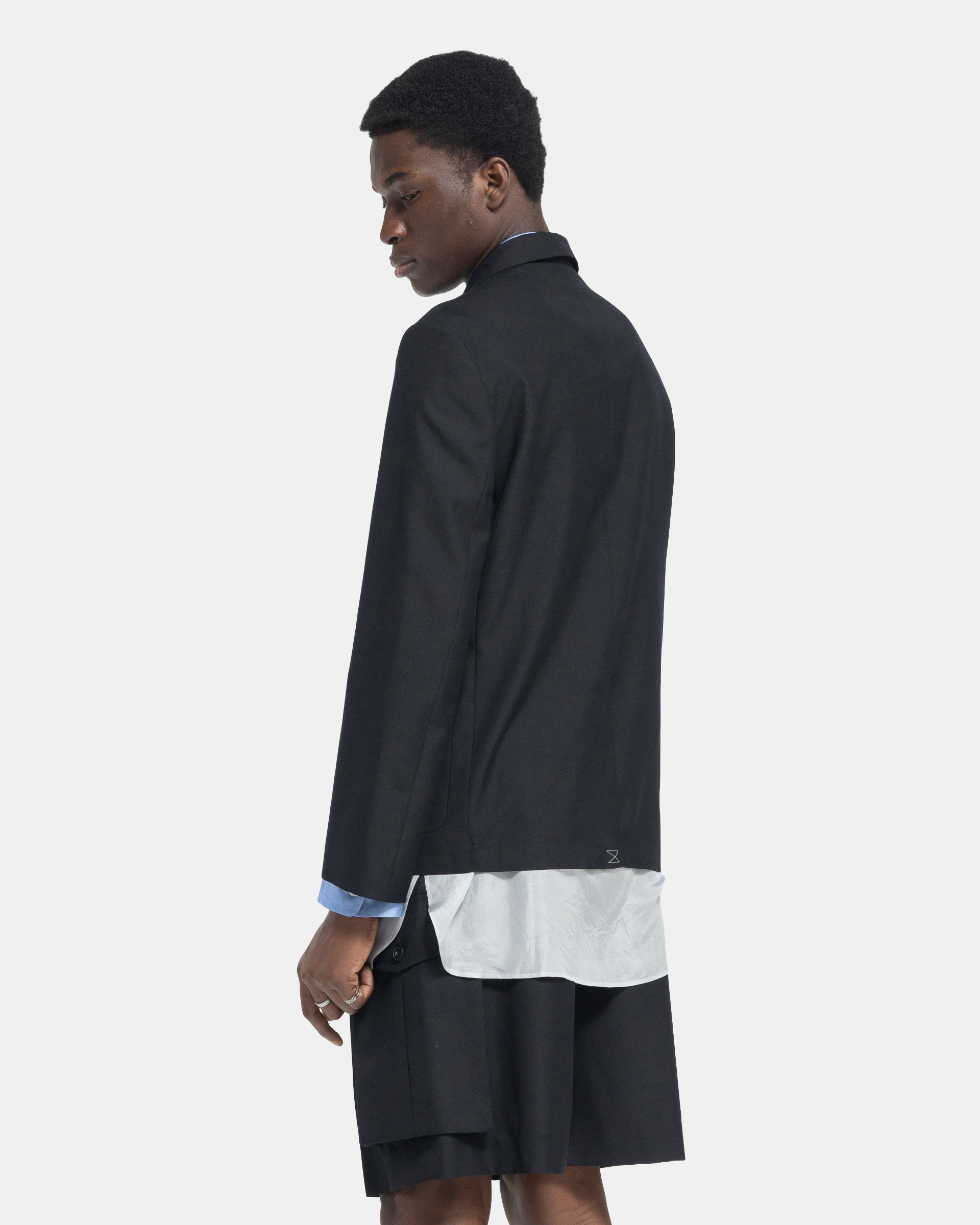 Model wearing Dries Van Noten Barleys Jacket in Black on white background