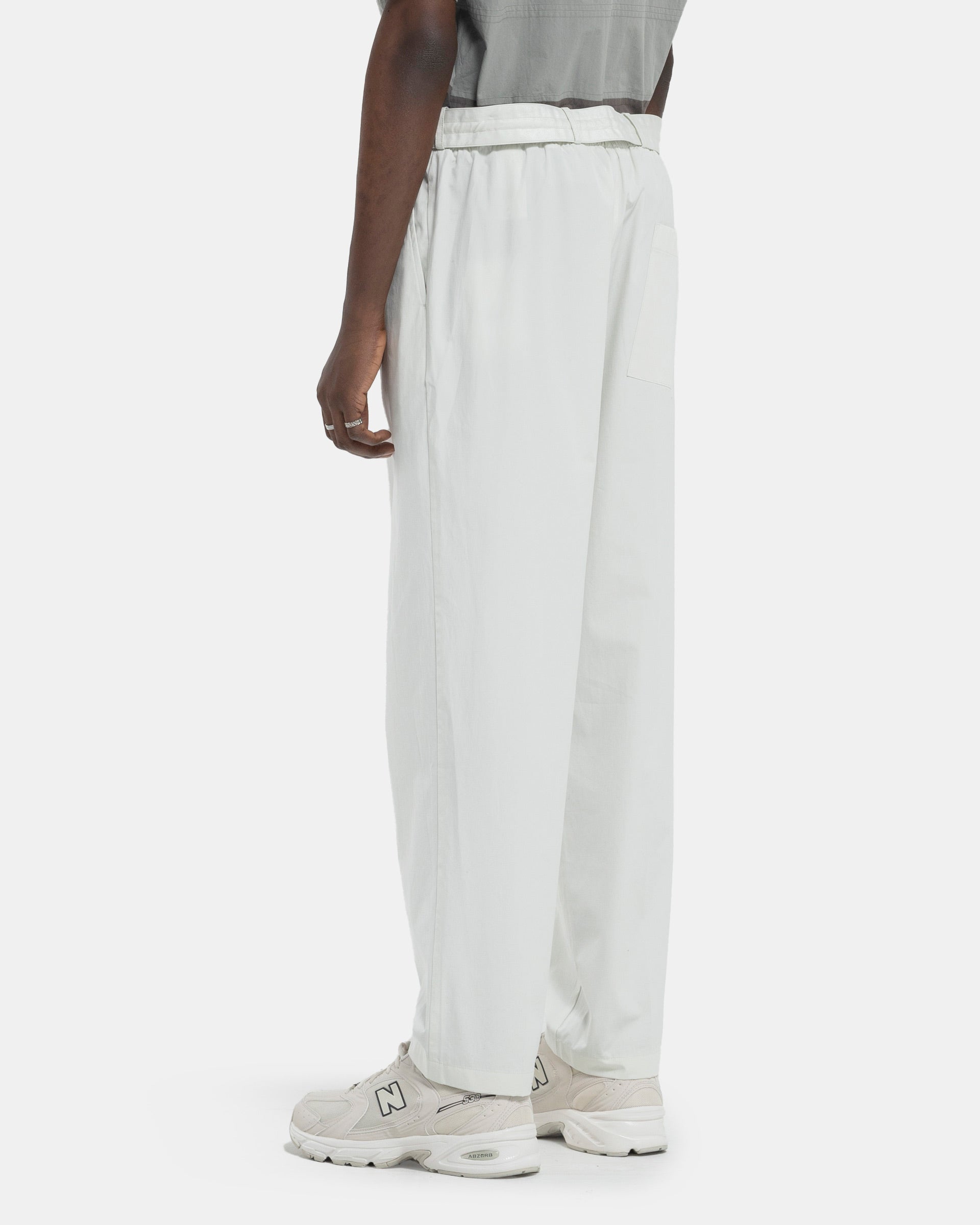 Model wearing Craig Green Circle Worker Trouser in Ecru on white background