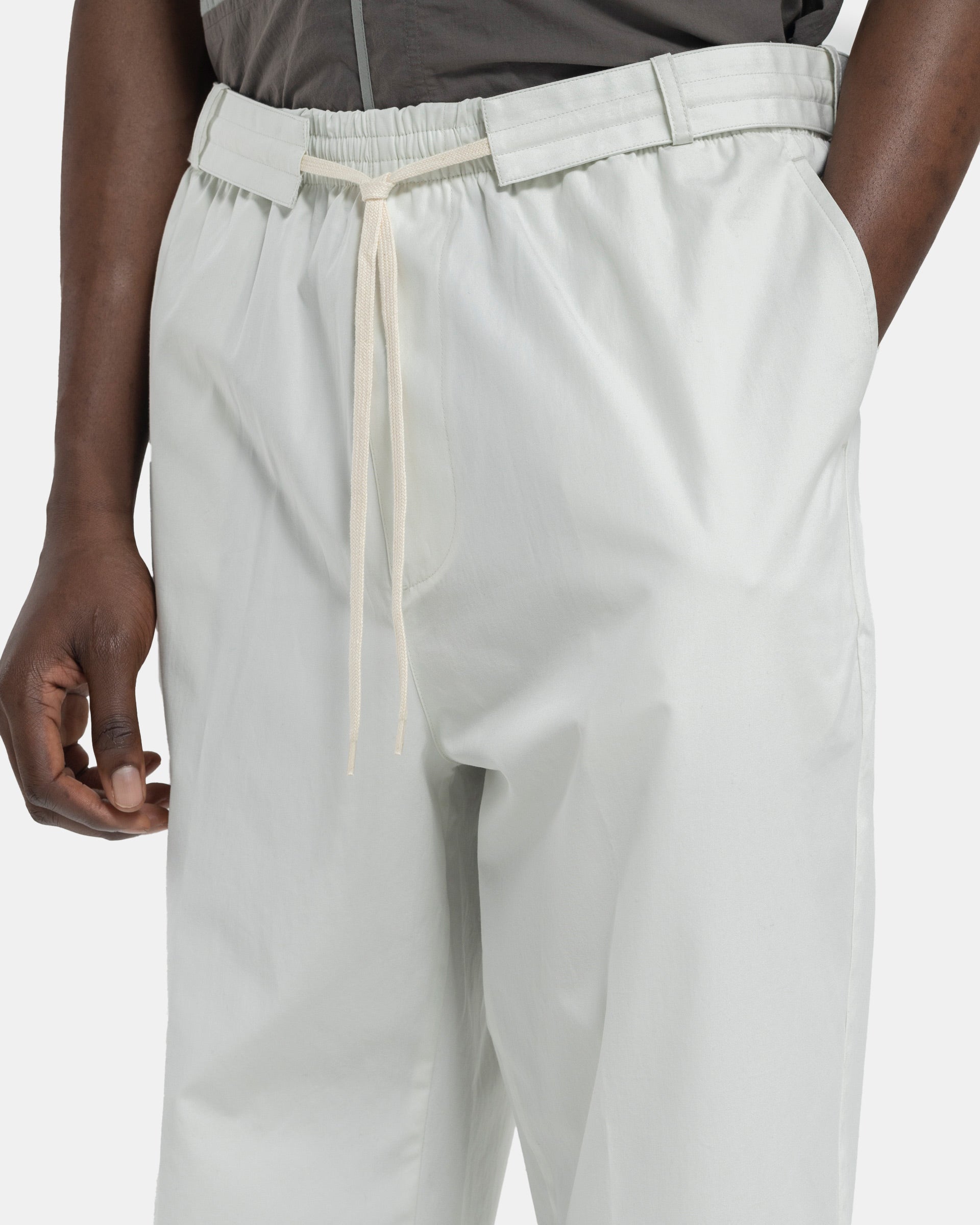 Close up of Model wearing Craig Green Circle Worker Trouser in Ecru on white background