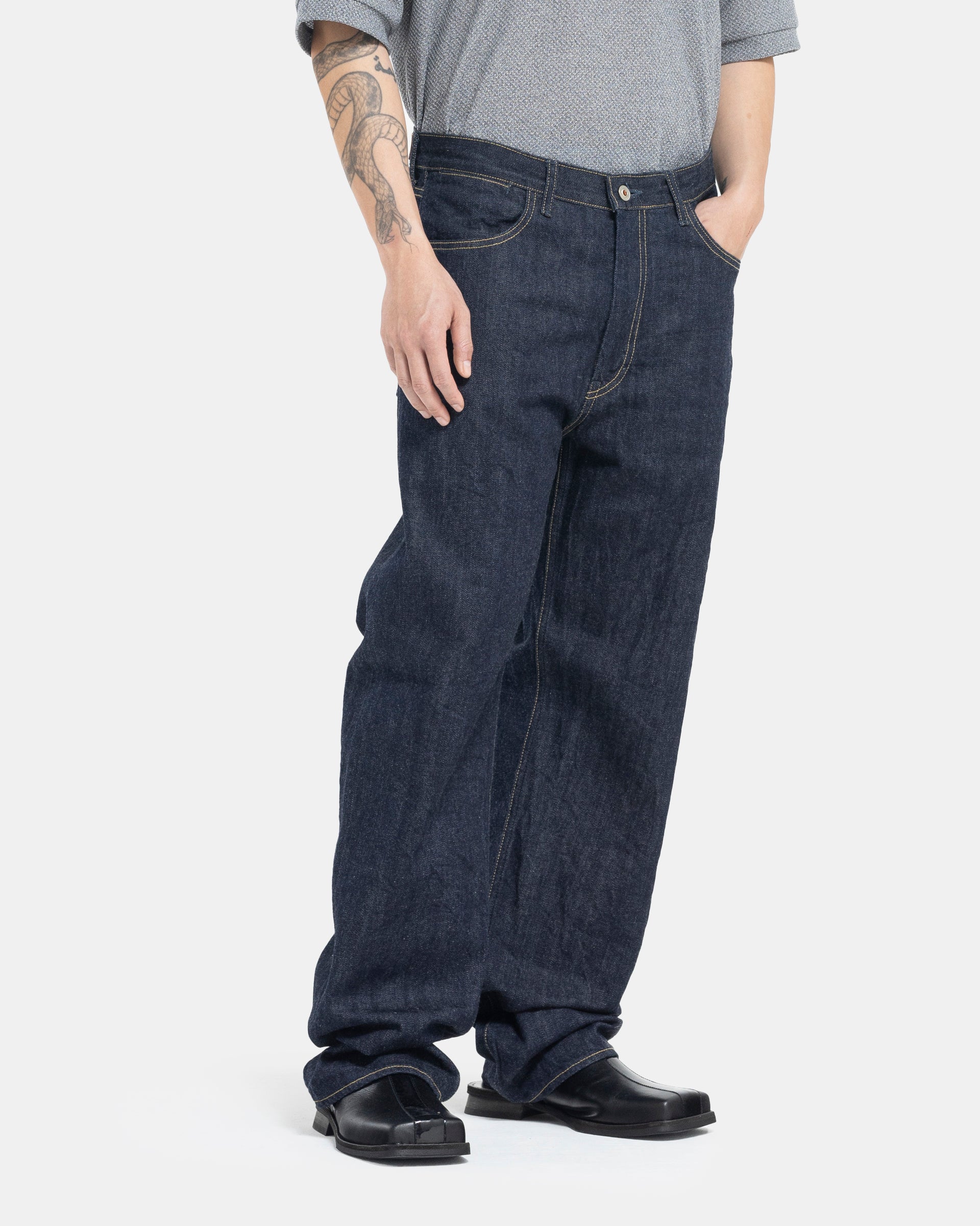 Male model wearing indigo Still By Hand selvedge jeans on white background
