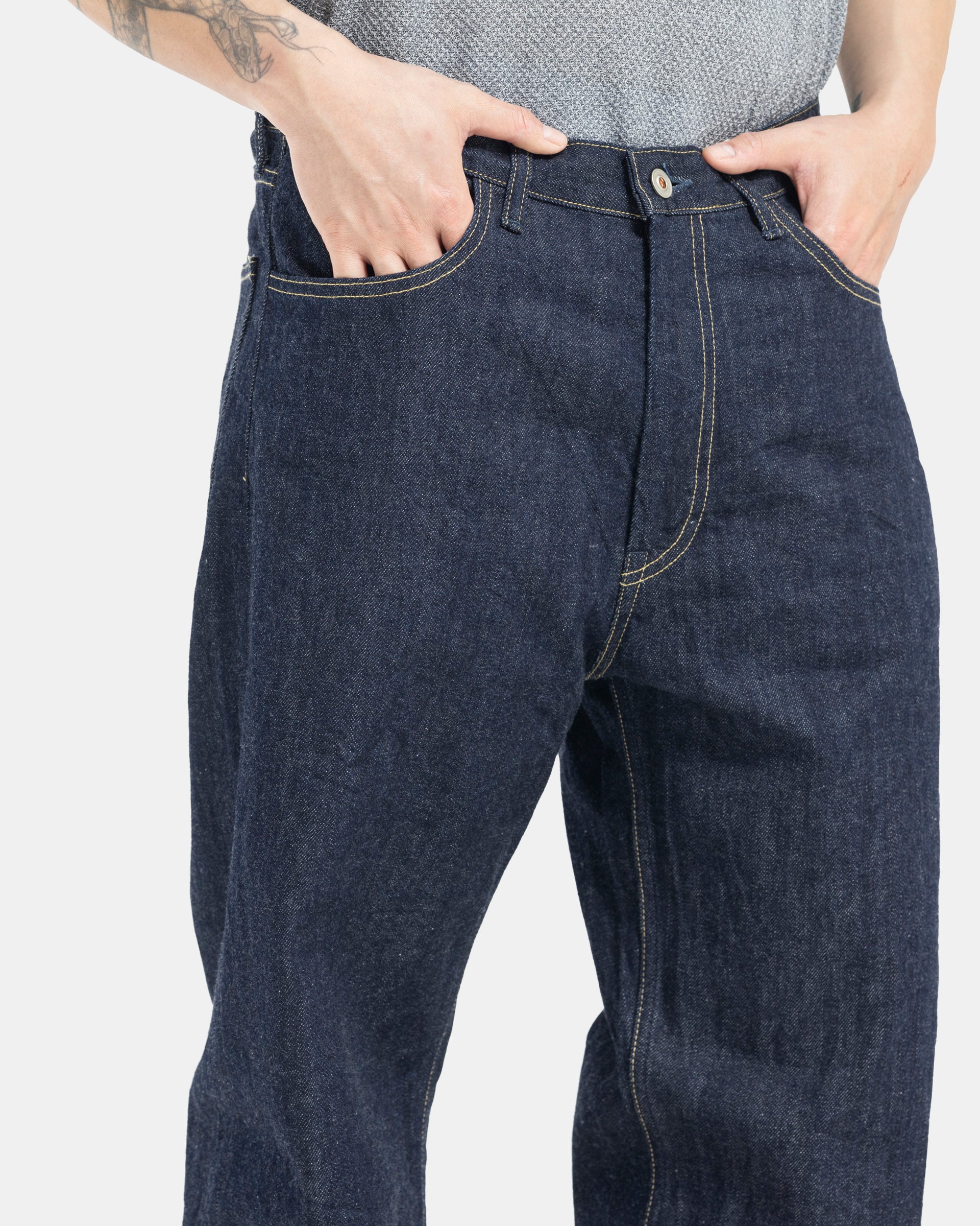 Male model wearing indigo Still By Hand selvedge jeans on white background