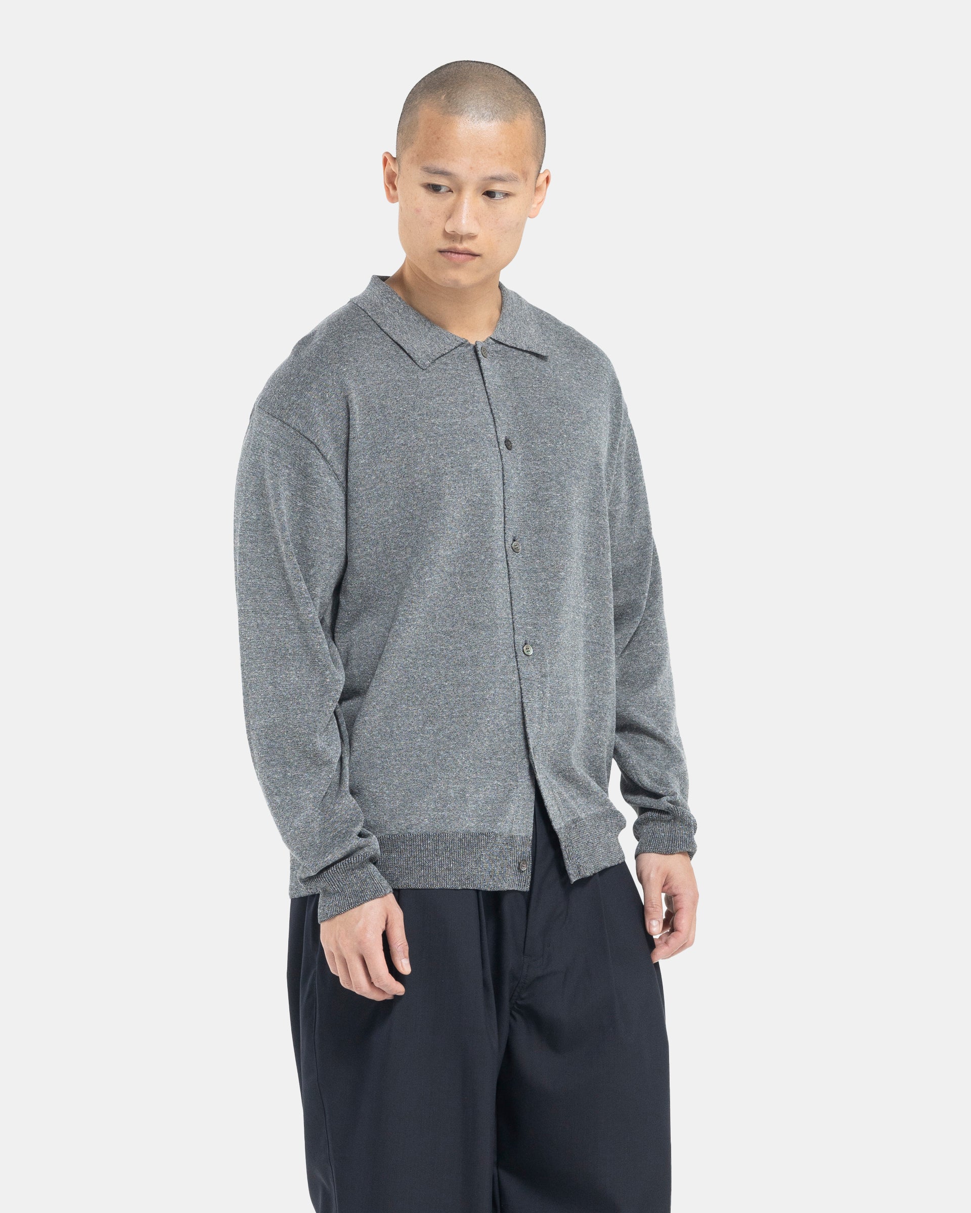 Male model wearing grey Still By Hand polo cardigan on white background