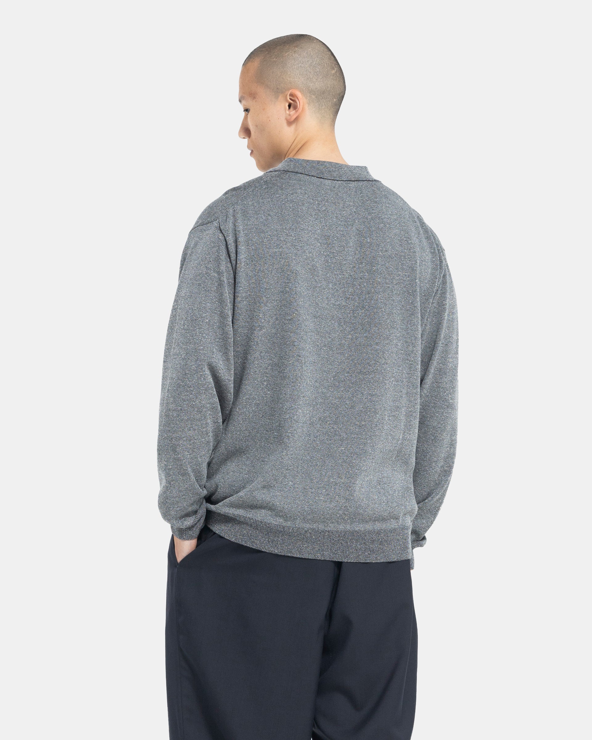 Male model wearing grey Still By Hand polo cardigan on white background