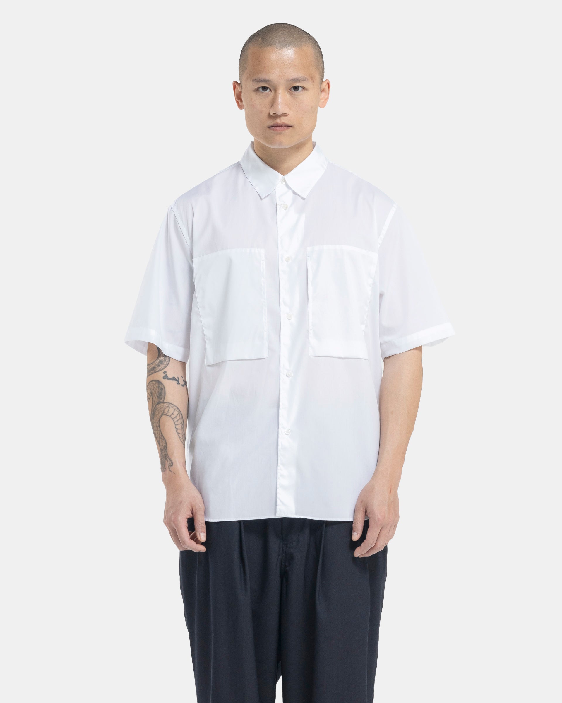 Male model wearing white Still By Hand shortsleeve shirt on white background