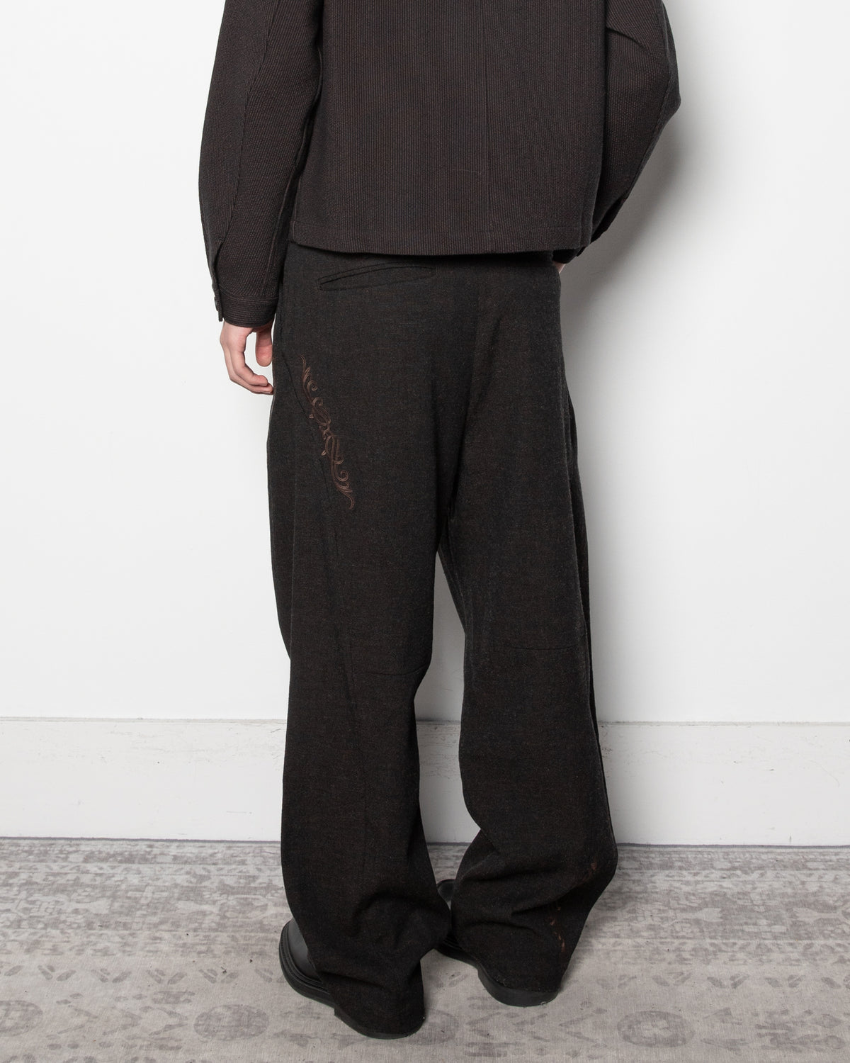 Embroidered Overlock Trousers in Black
