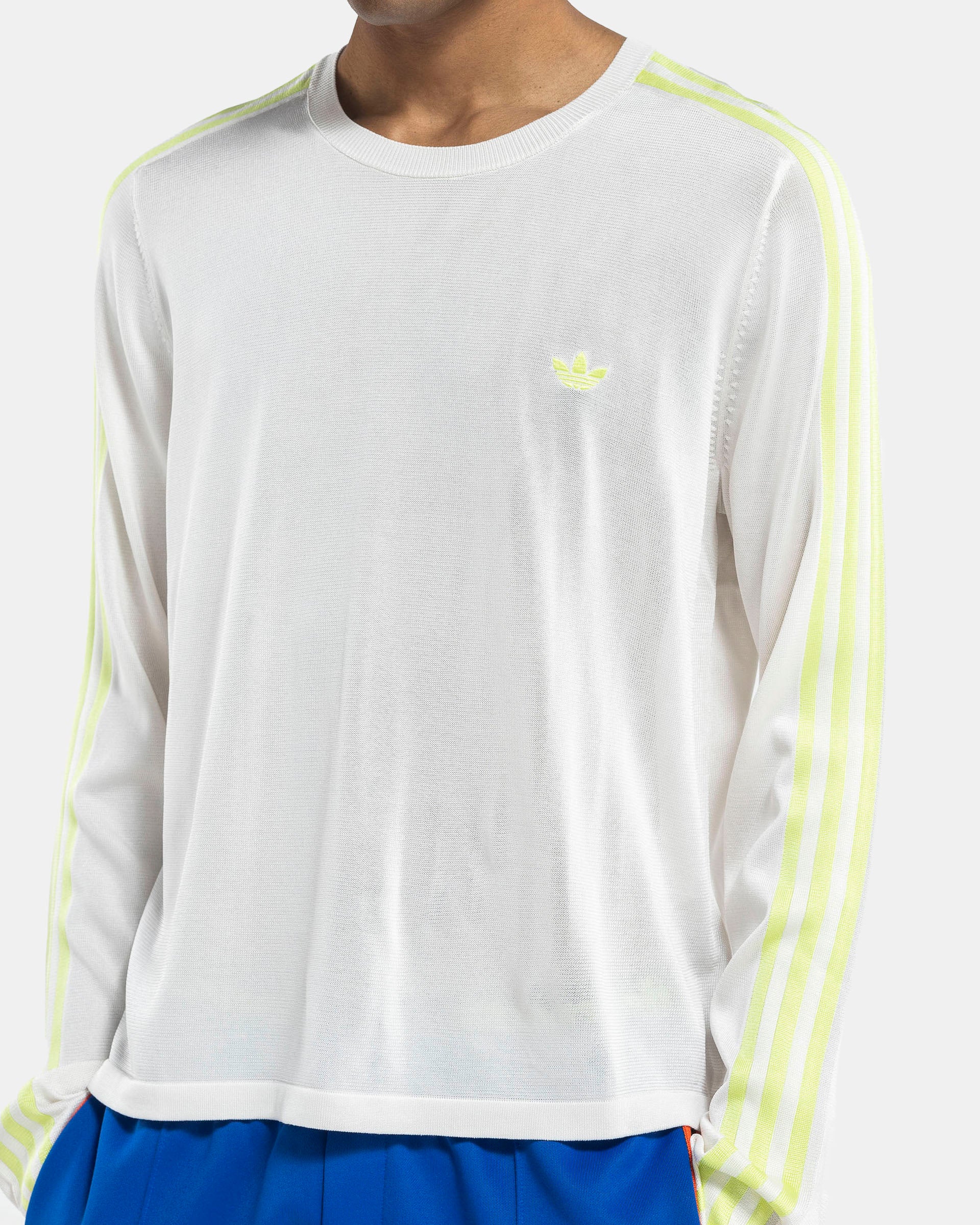 Model wearing Adidas Wales Bonner Knit LST-shirt in Chalk White on the white background