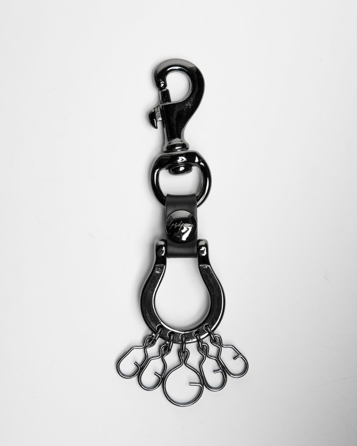 A black metal keychain accessory featuring a lobster clasp, swivel snap, D-ring, and a dangling multi-ring keychain chain, shown on a light gray background.