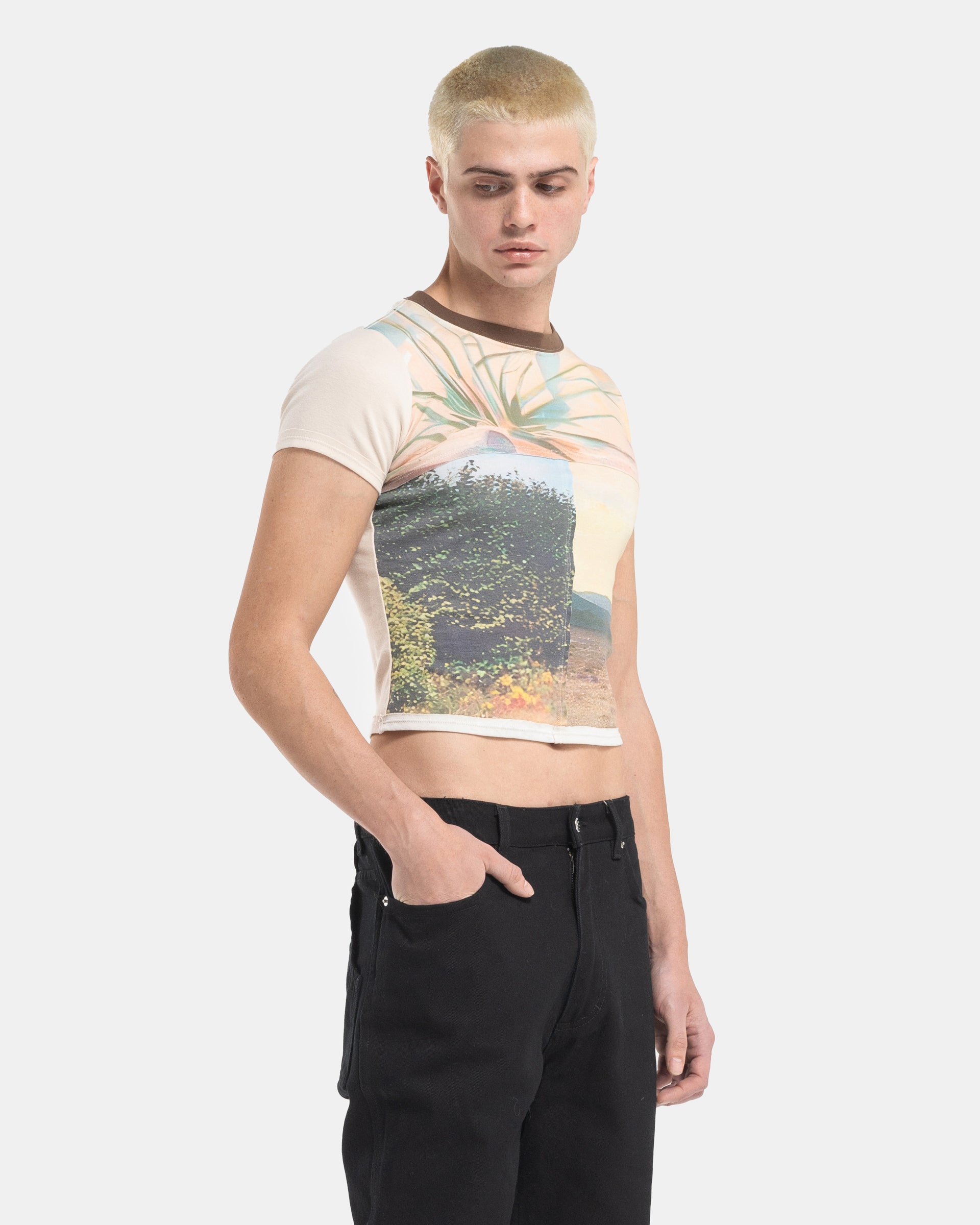 Male model wearing a Eckhaus Latta Lapped Baby Tee with a collage print design