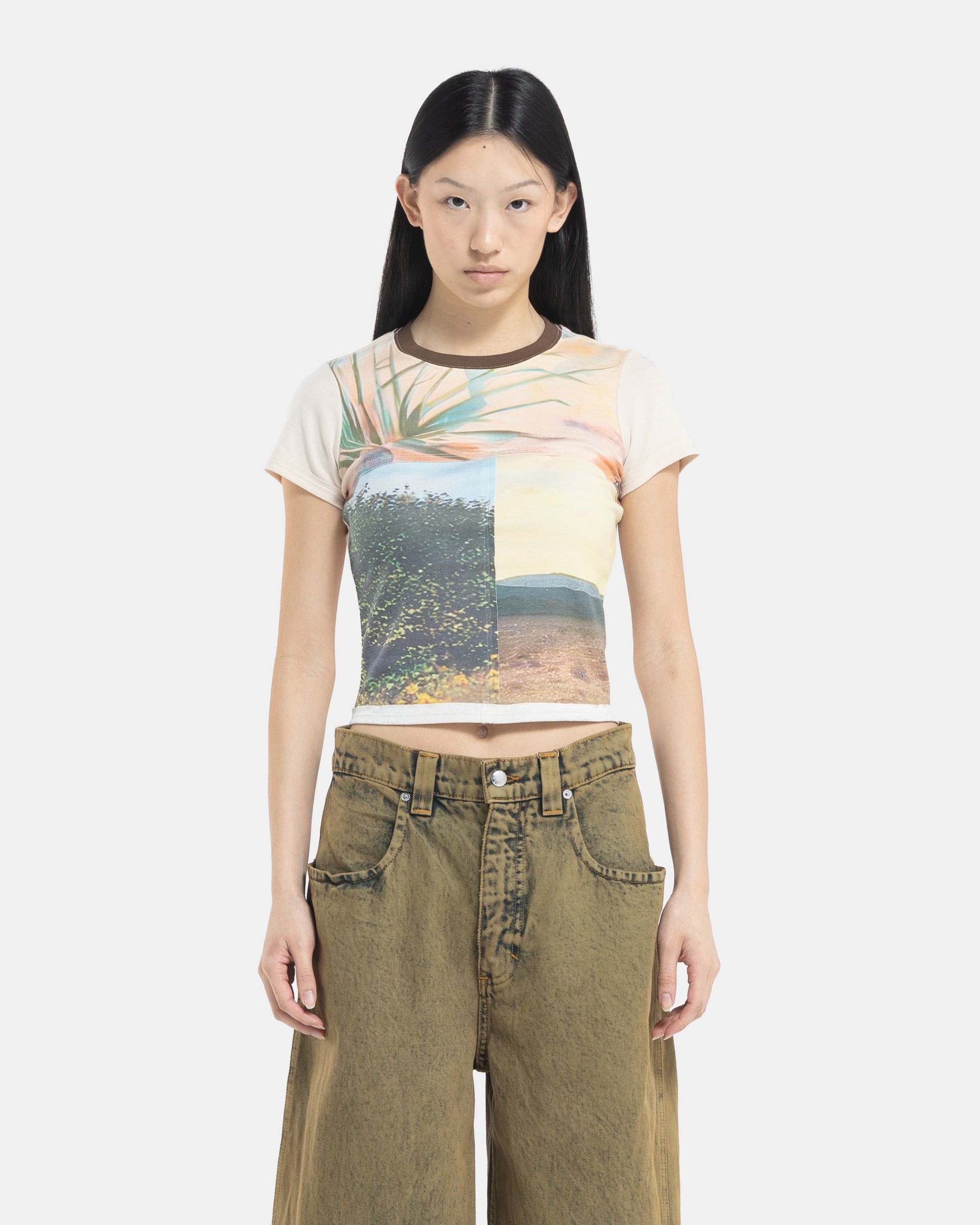 Female model wearing a Eckhaus Latta Lapped Baby Tee with a collage print design