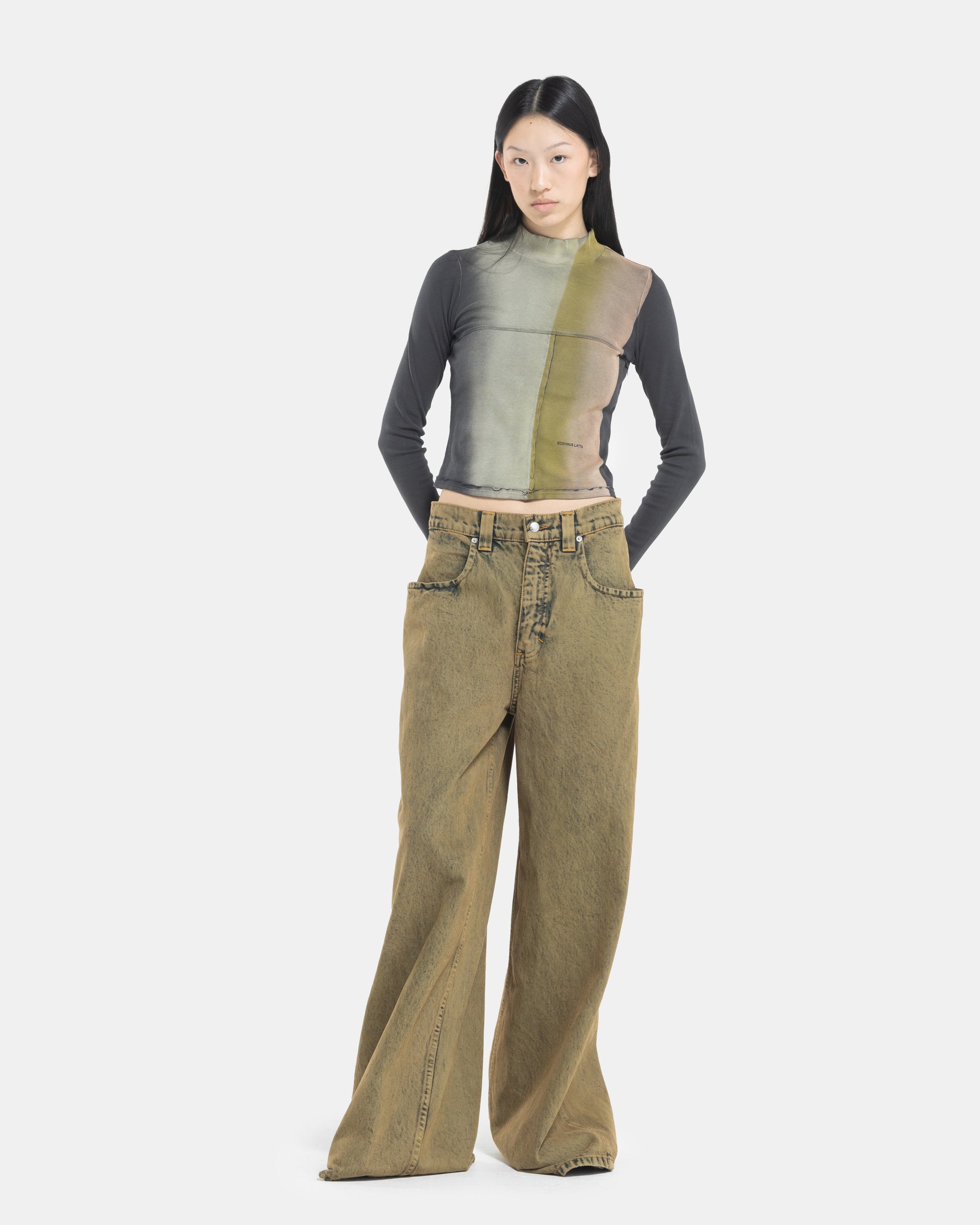Female model wearing a Eckhaus Latta Lapped Baby Turtleneck and ultra-wide jeans